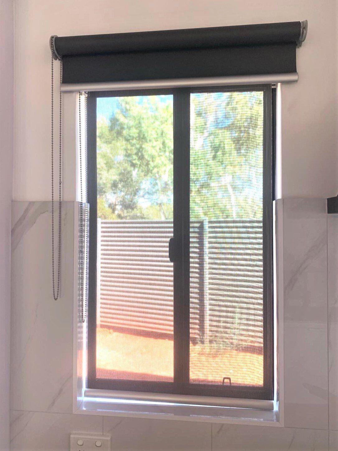 Window with Black Roller Shade and Pleated Blinds — Alice Mobile Blinds in Ciccone, NT