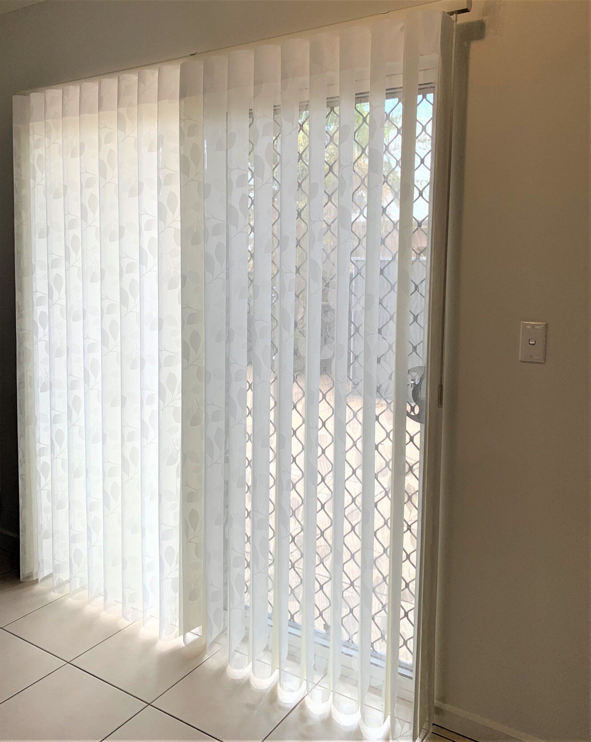 White Vertical Blinds Cover a Sliding Glass Door — Alice Mobile Blinds in Ciccone, NT