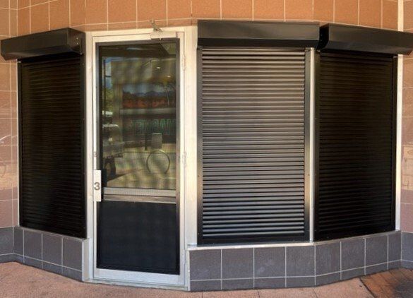 Exterior Storefront with Roll-Down Security Shutters Closed — Alice Mobile Blinds in Ciccone, NT