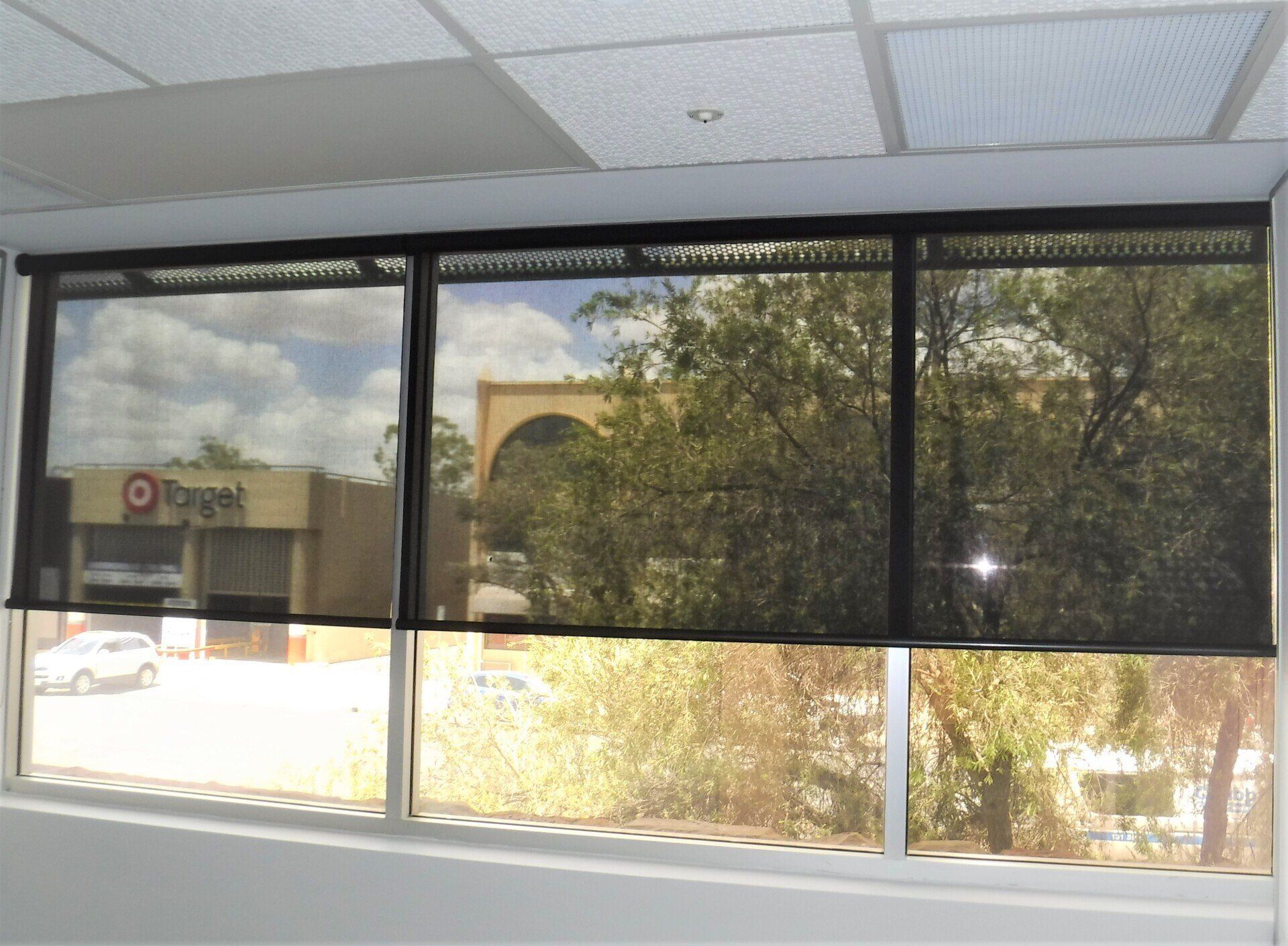 Three Windows with Black Roller Shades — Alice Mobile Blinds in Ciccone, NT