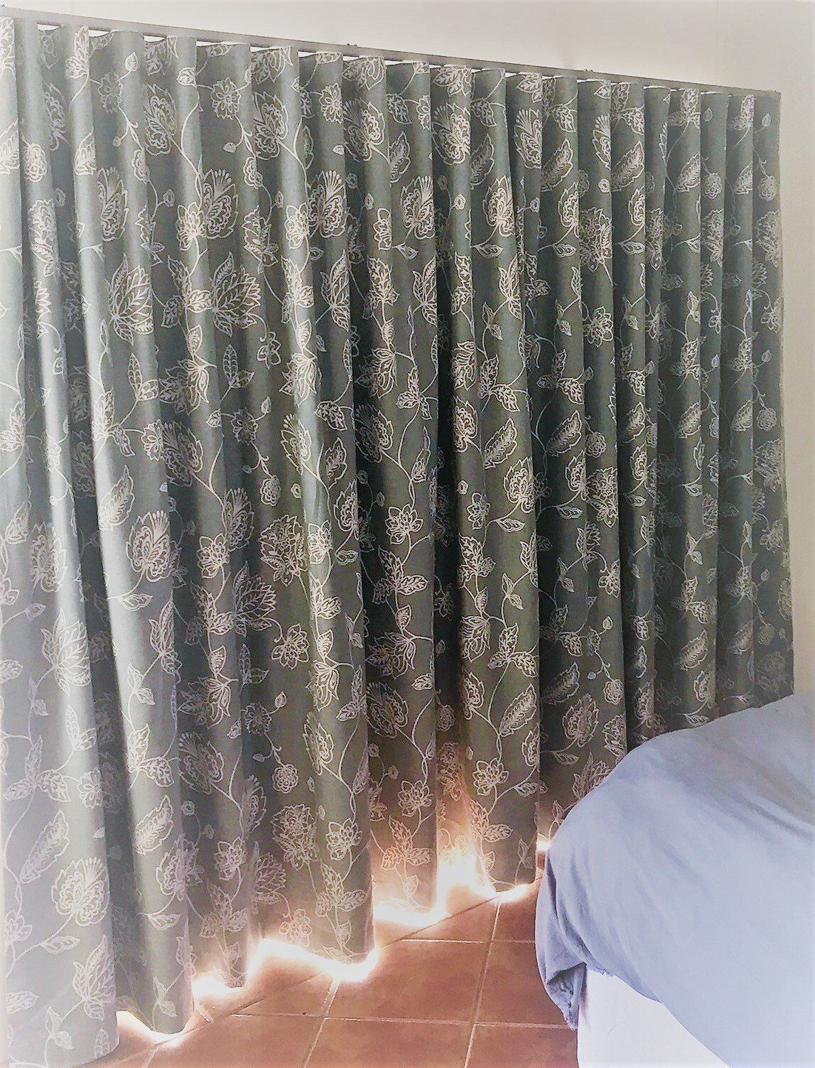 Dark Green Patterned Curtains Partially Covering a Window — Alice Mobile Blinds in Ciccone, NT