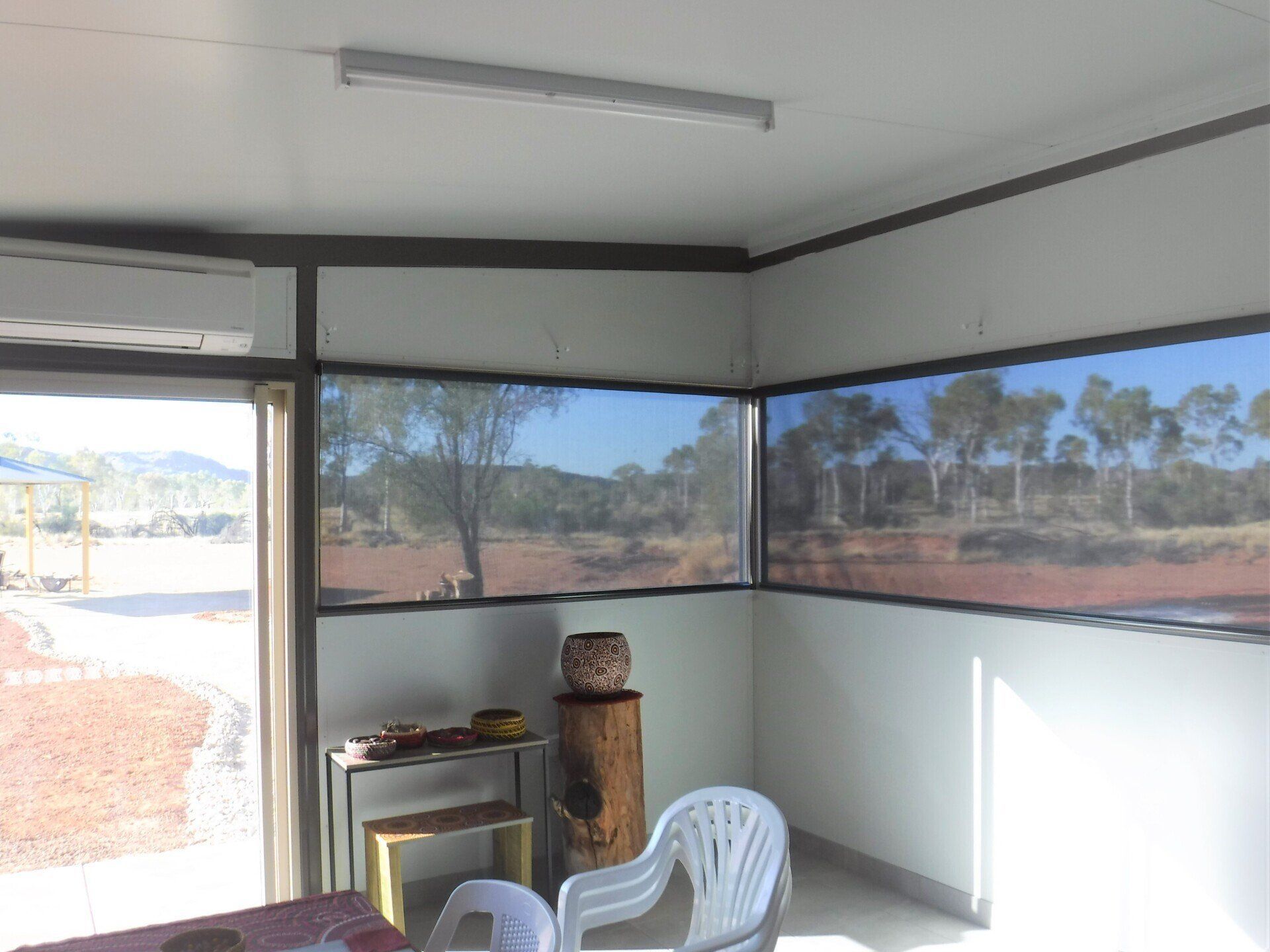 Interior Room with Window Views of Trees and Arid Landscape — Alice Mobile Blinds in Ciccone, NT