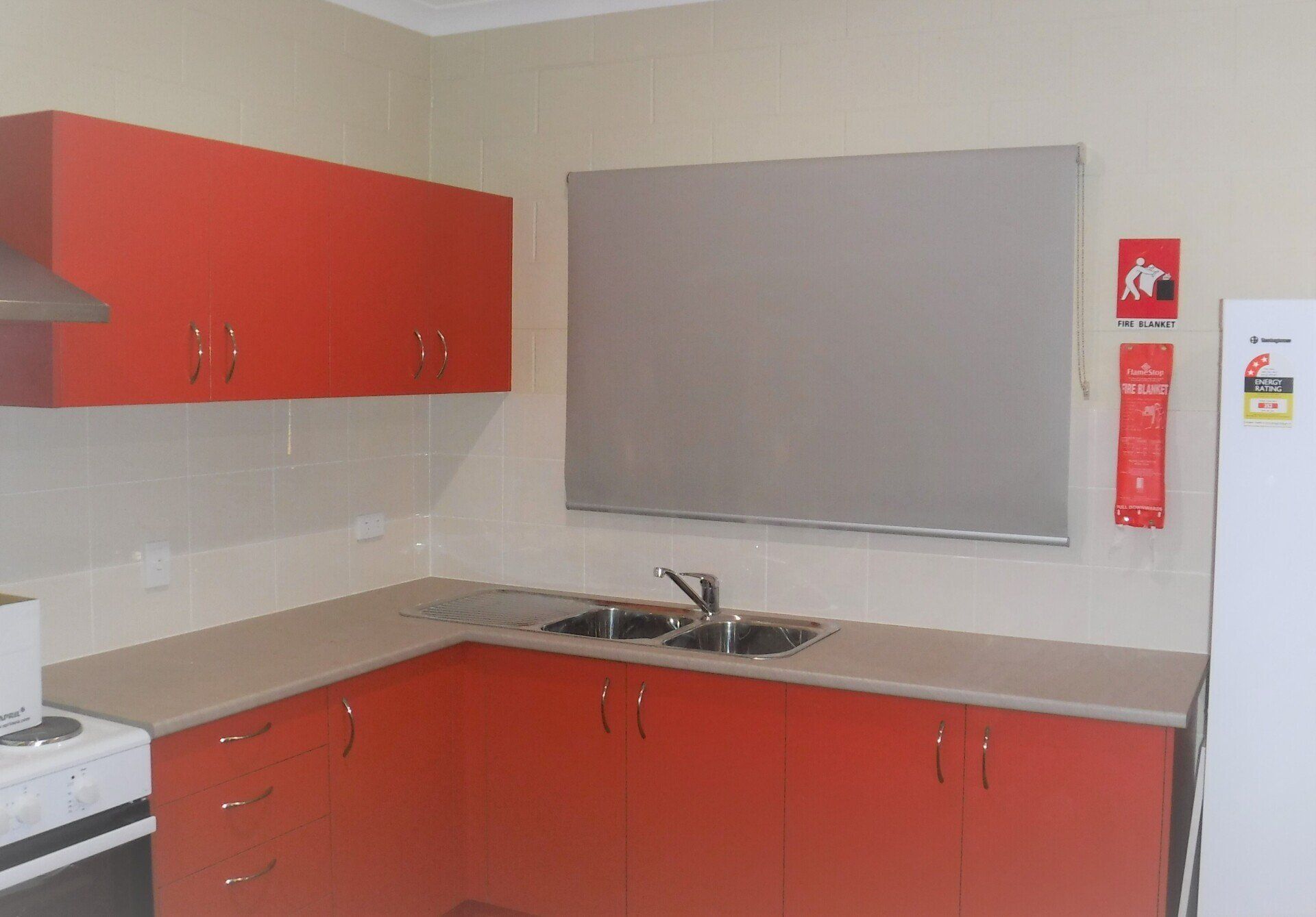 Red Kitchen Cabinets with Grey Countertops — Alice Mobile Blinds in Ciccone, NT