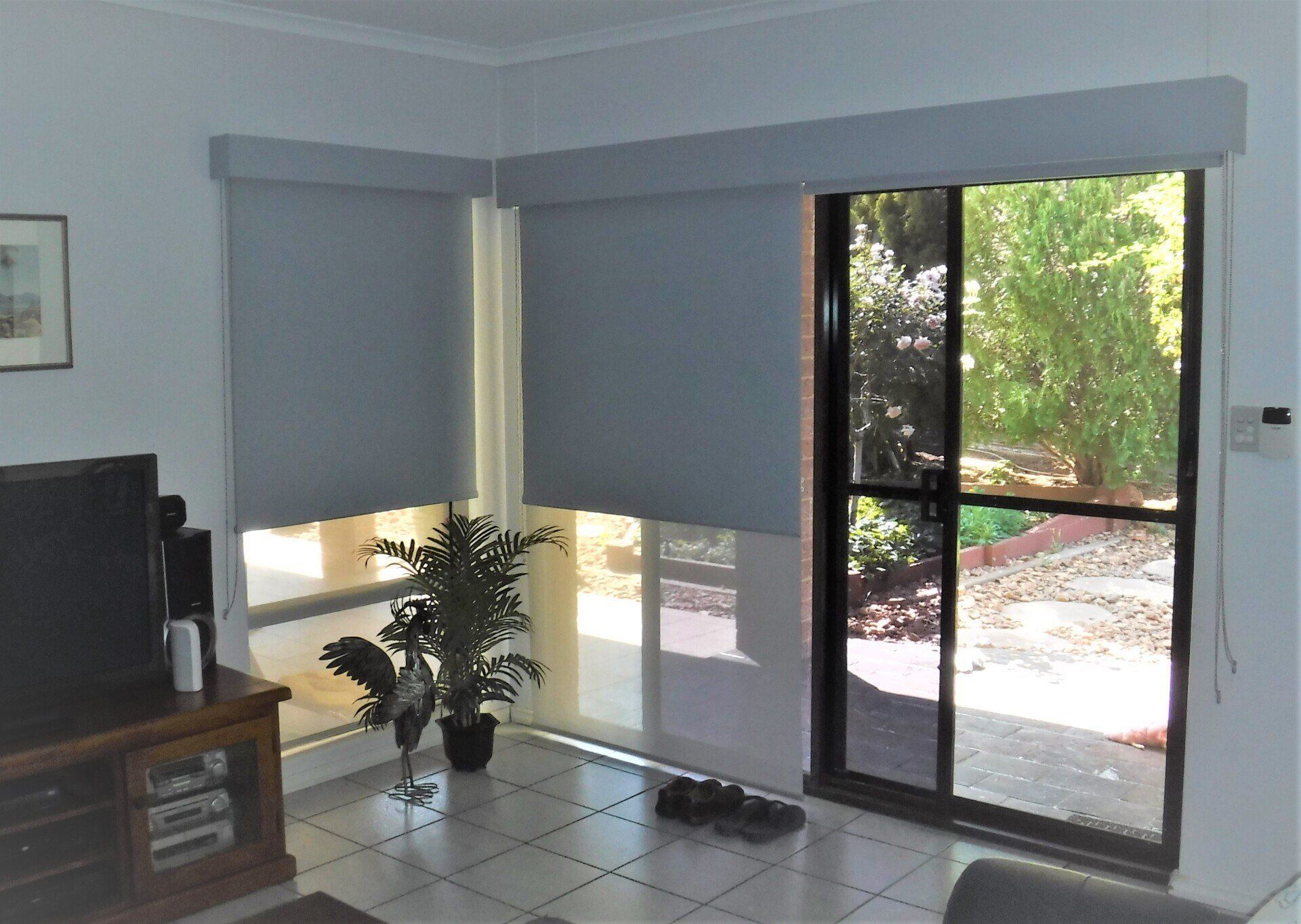 Living Room with Grey Blinds Over Windows — Alice Mobile Blinds in Ciccone, NT
