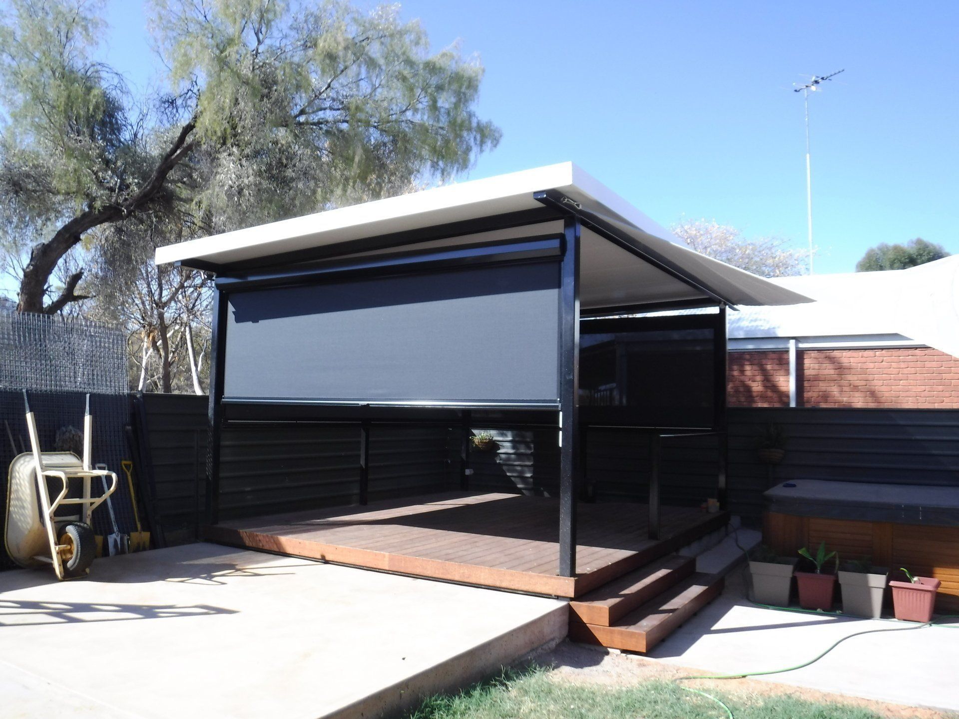 Outdoor Patio with A White Roof, Black Frame and Roll-Down Shade — Alice Mobile Blinds in Ciccone, NT
