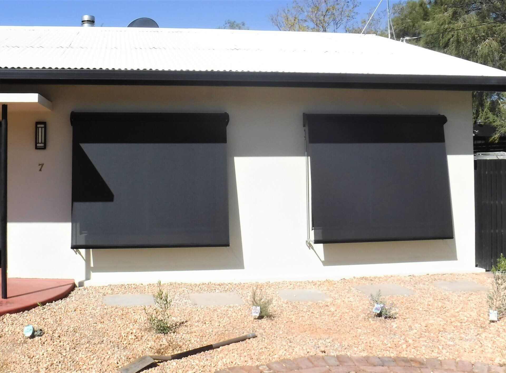 Beige House with A White Roof and Two Black Exterior Blinds — Alice Mobile Blinds in Ciccone, NT