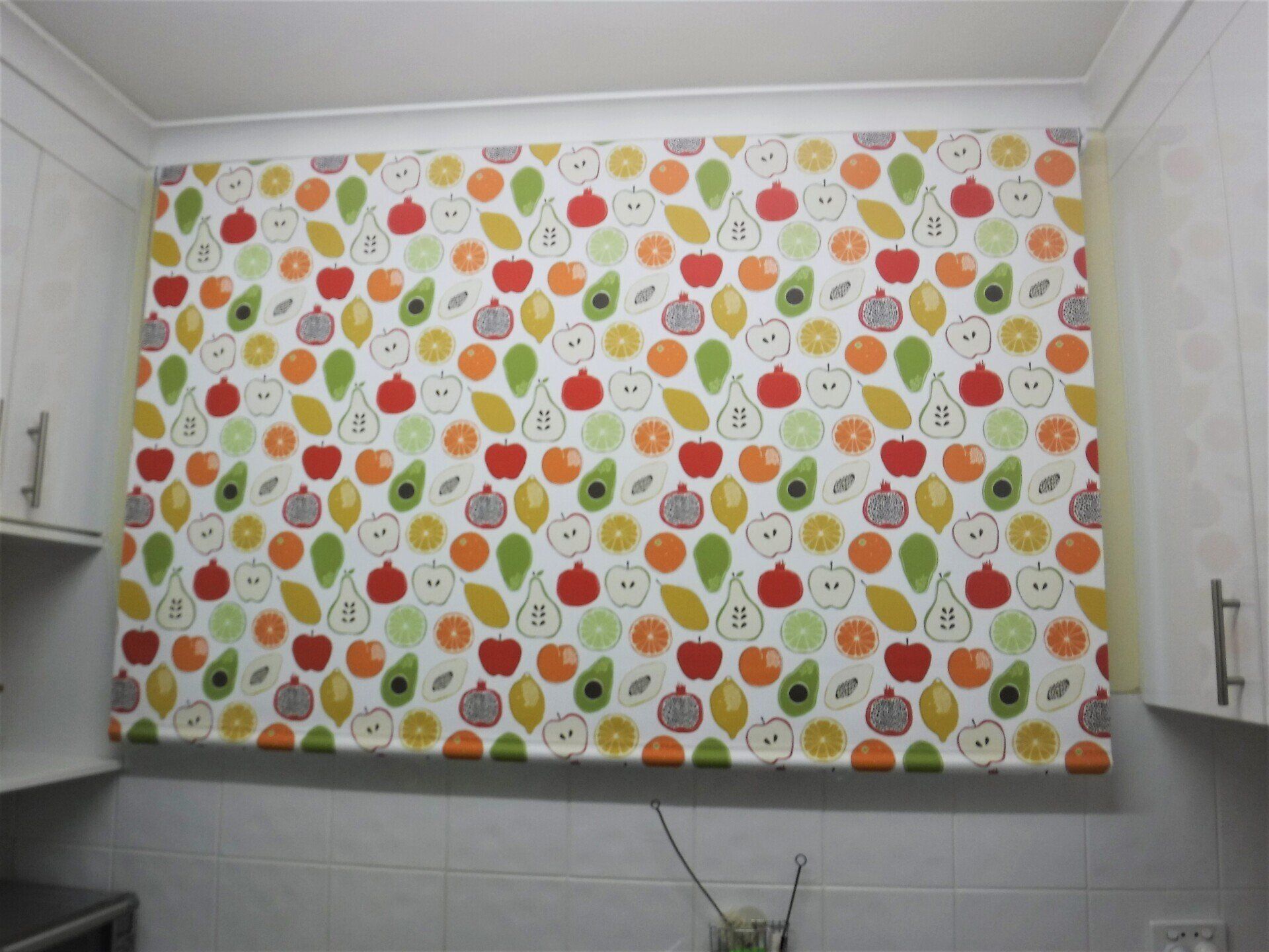 Fruit-Patterned Kitchen Blind Above a Tiled Backsplash — Alice Mobile Blinds in Ciccone, NT