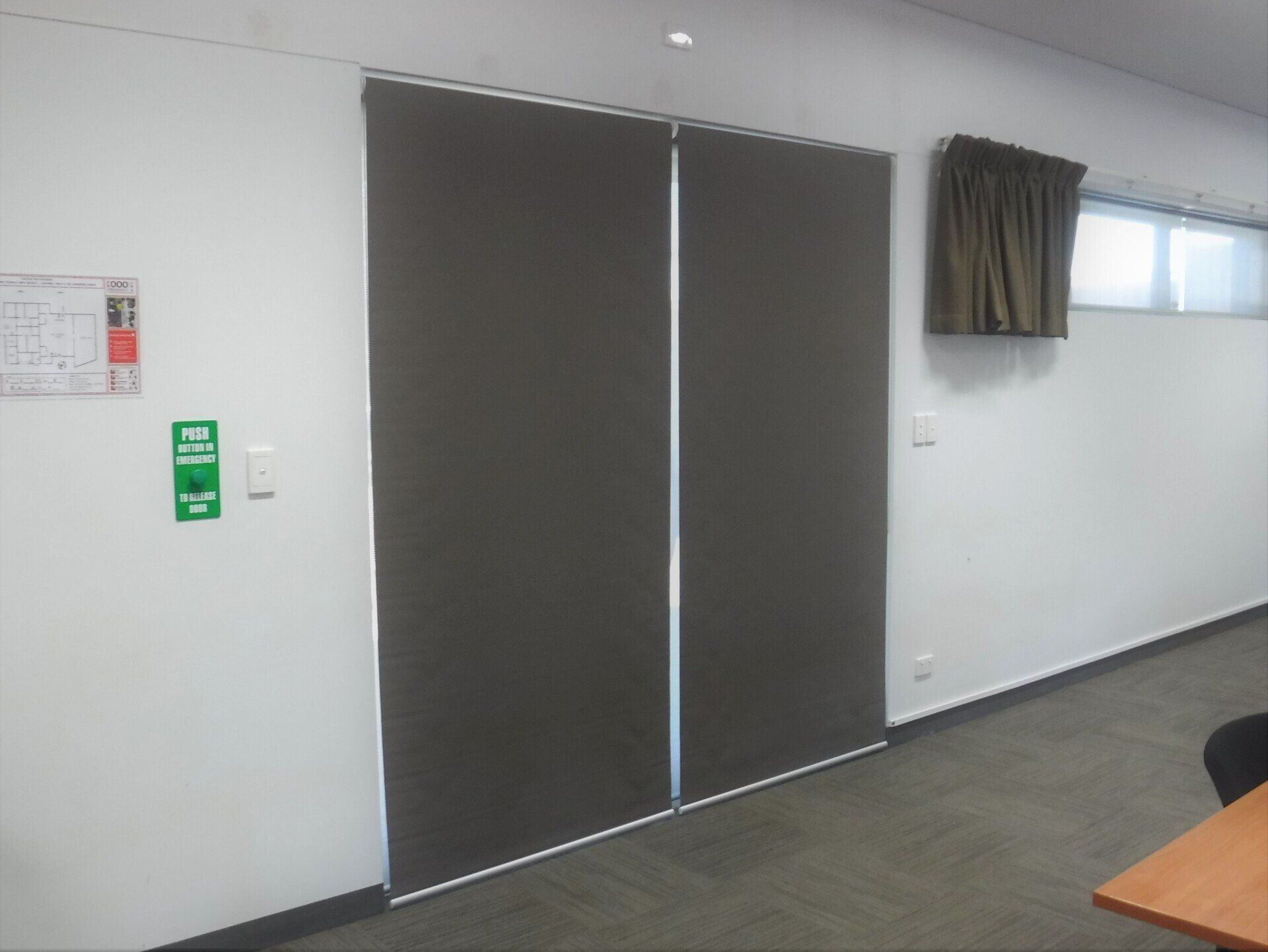 Two Dark Grey Roller Shades Covering a Doorway — Alice Mobile Blinds in Ciccone, NT
