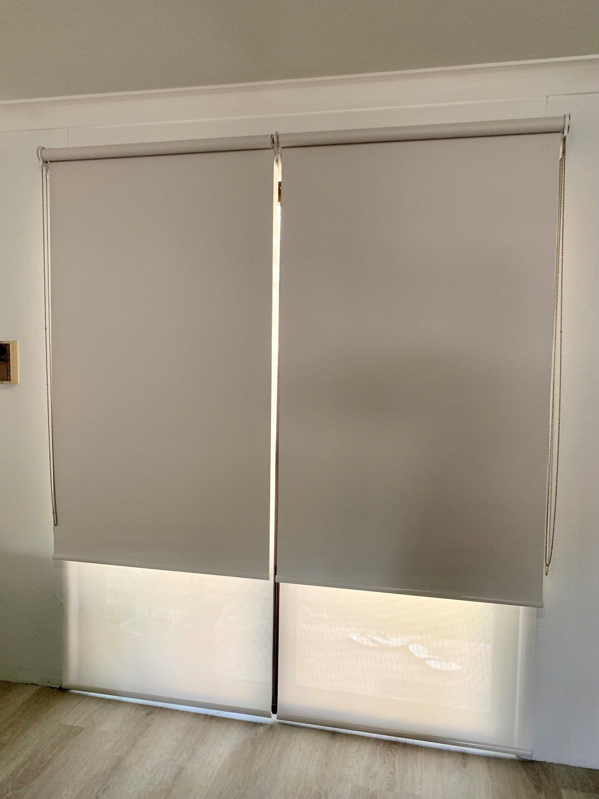 Two Beige Roller Blinds Partially Cover a Window — Alice Mobile Blinds in Ciccone, NT