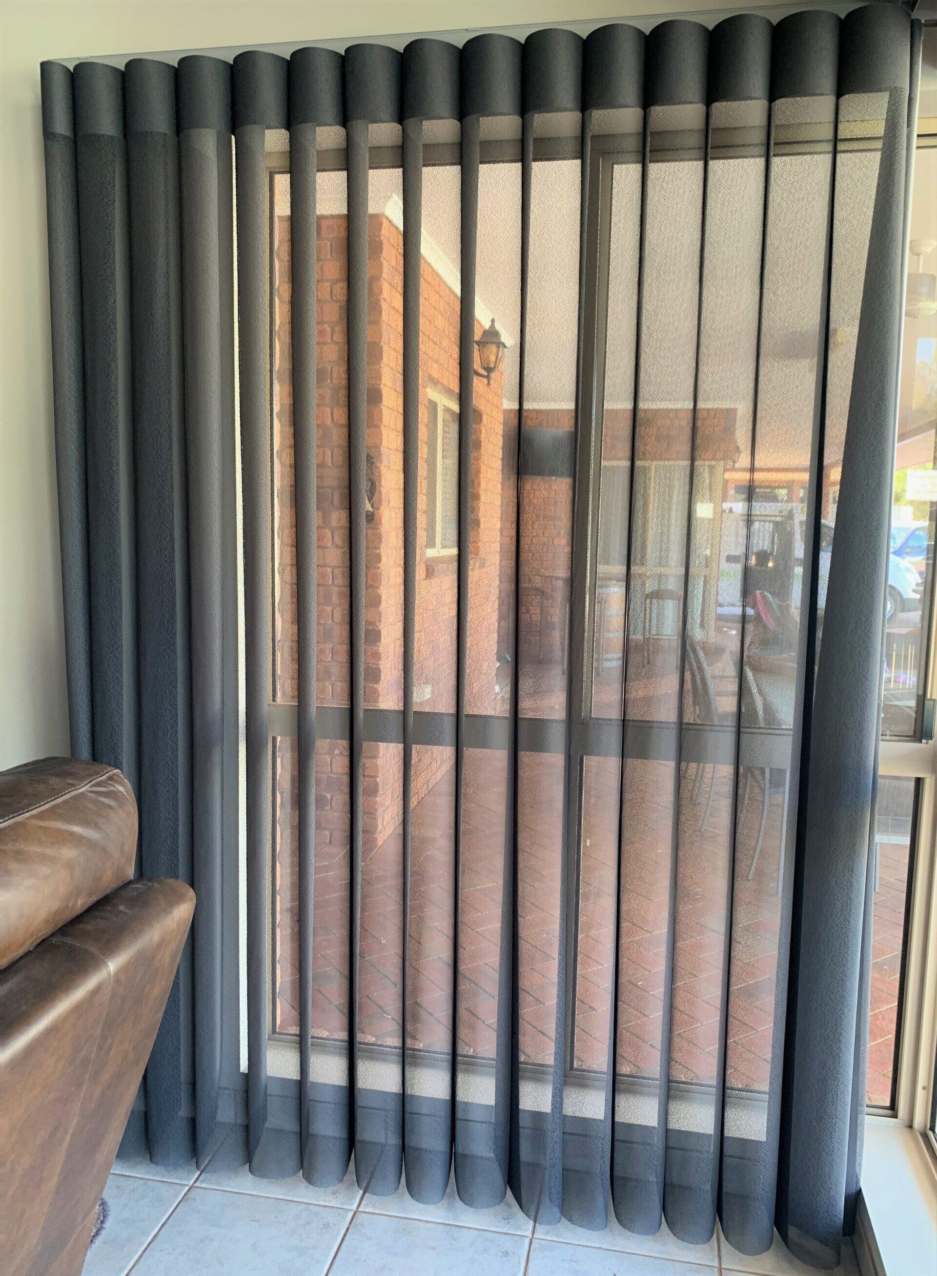 Dark Grey Vertical Window Blinds Covering a Glass Sliding Door — Alice Mobile Blinds in Ciccone, NT