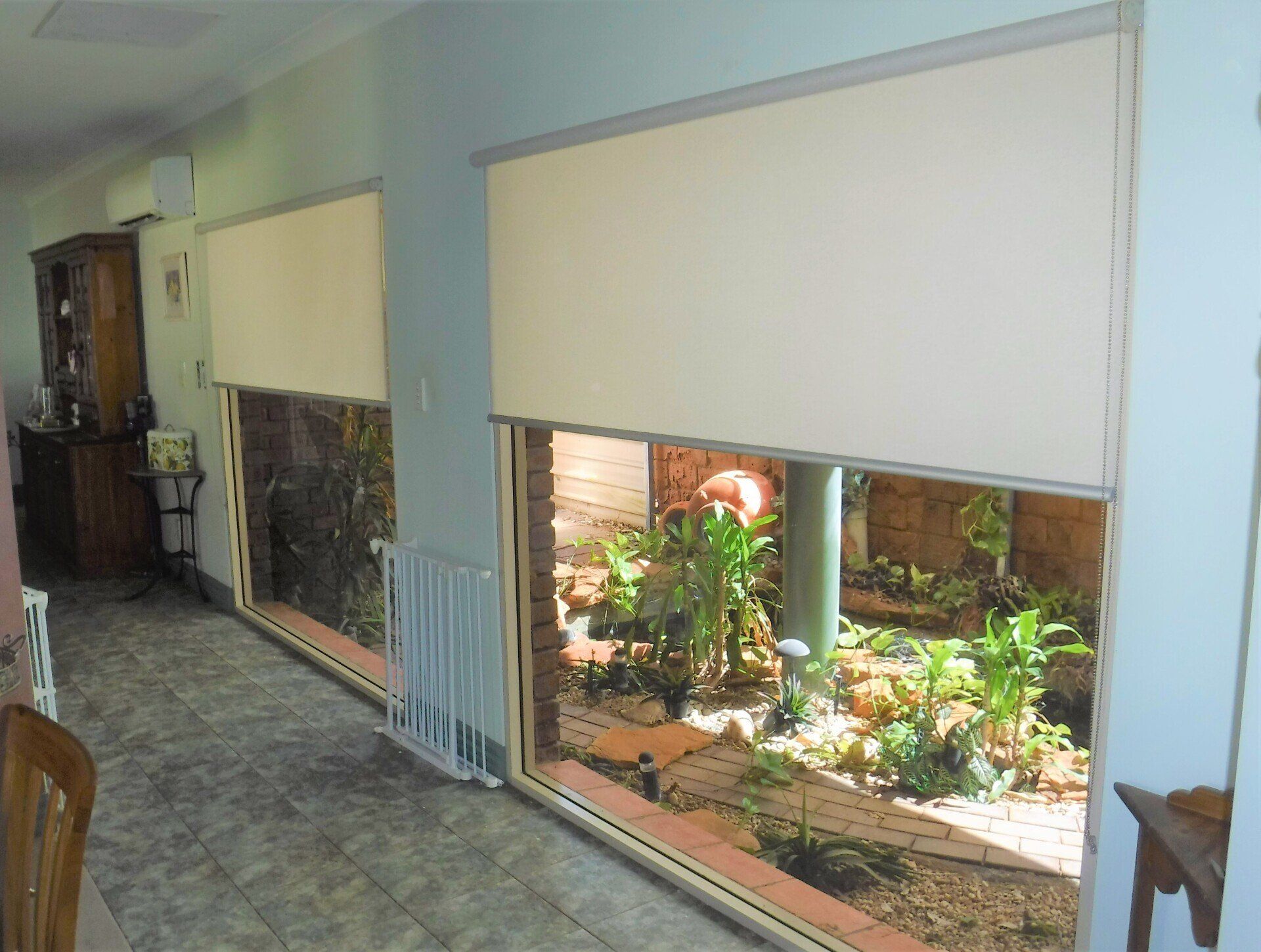 Two Windows with Drawn Blinds Overlooking a Garden — Alice Mobile Blinds in Ciccone, NT