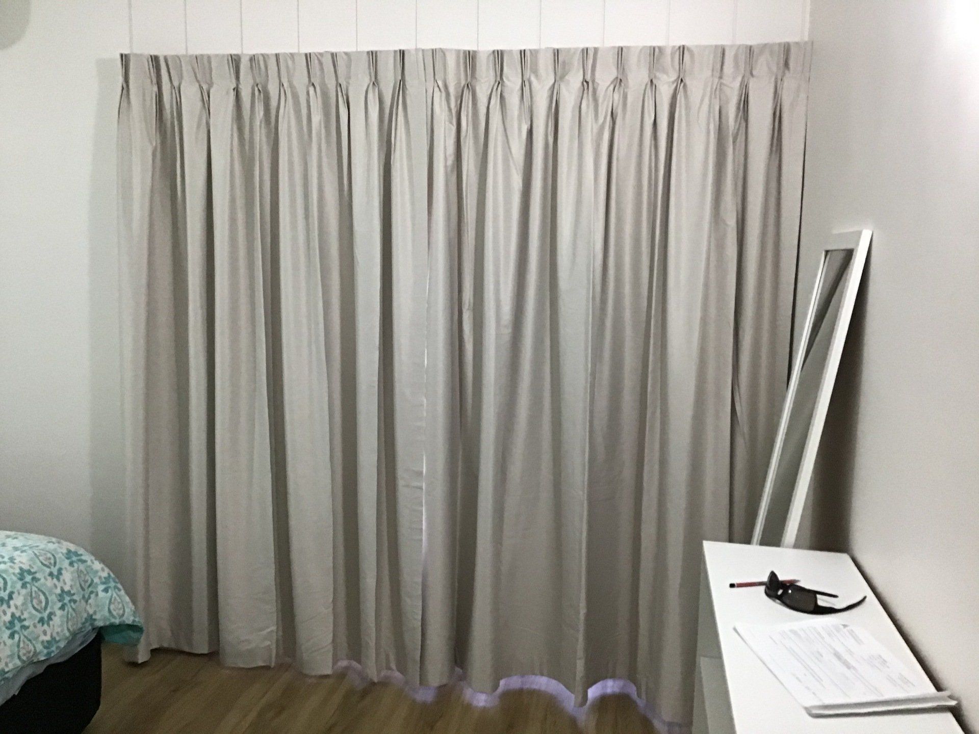 Beige Pleated Curtains Hung Against a White Wall — Alice Mobile Blinds in Ciccone, NT