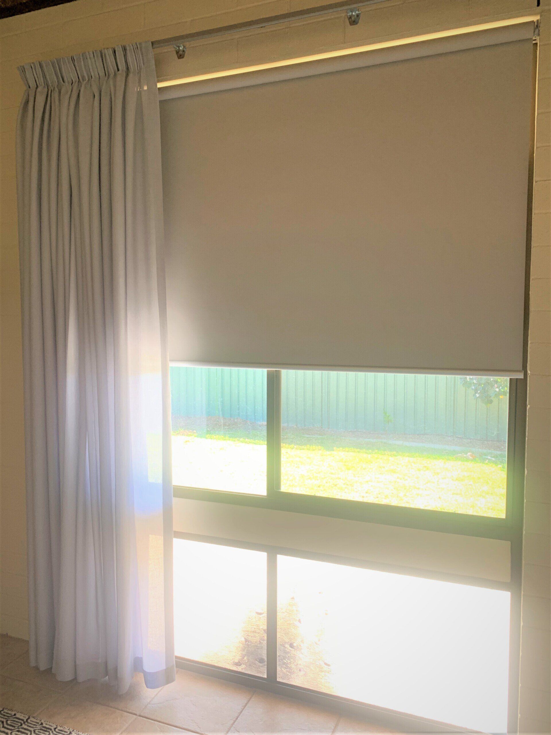 Window with Light Grey Roller Blind and Sheer Curtain — Alice Mobile Blinds in Ciccone, NT