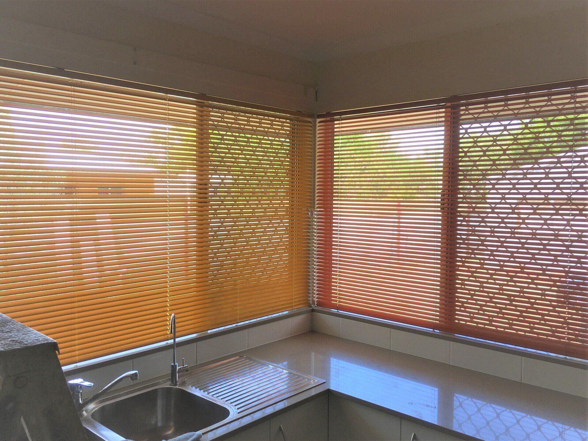 Kitchen Corner with Orange Blinds — Alice Mobile Blinds in Ciccone, NT
