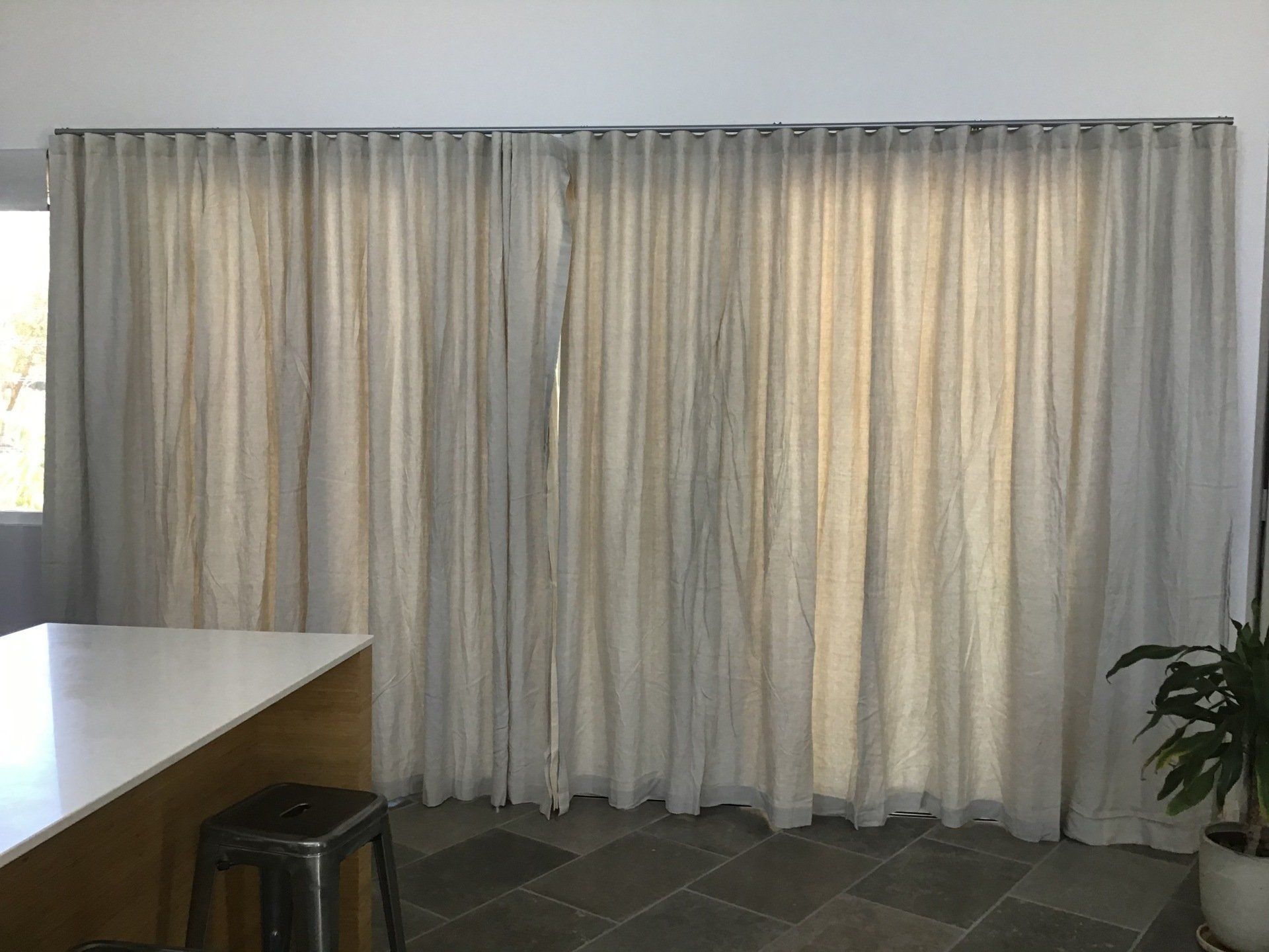 Beige Curtains Cover Large Windows in A Room — Alice Mobile Blinds in Ciccone, NT