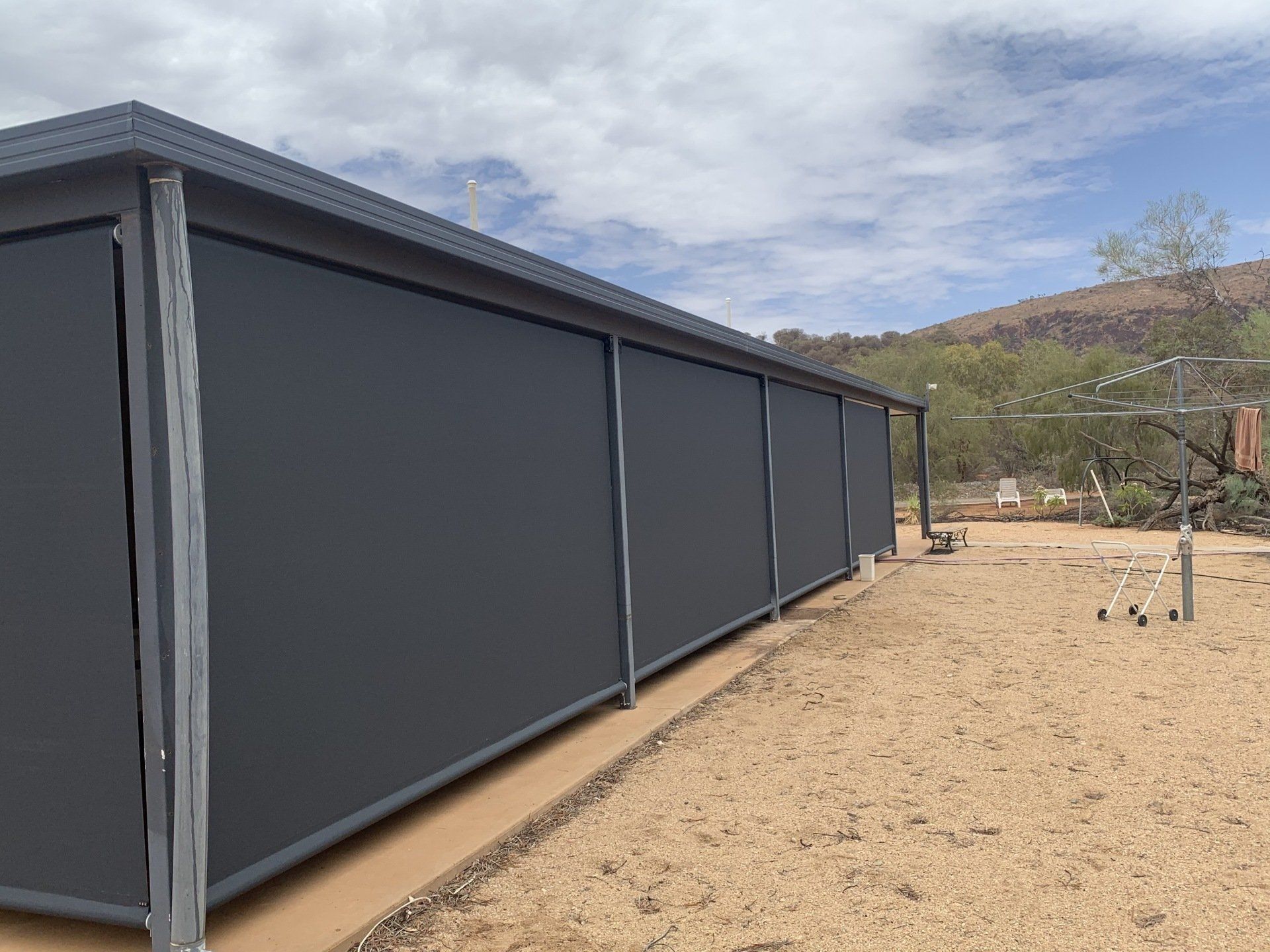 Dark Grey Outdoor Shades on A Building — Alice Mobile Blinds in Ciccone, NT