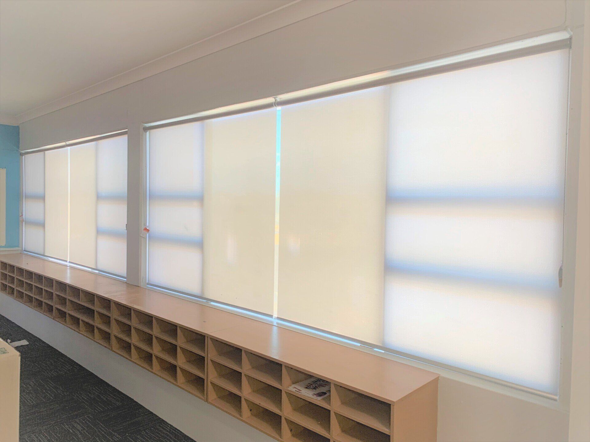Row of Windows with Light Beige Roller Blinds — Alice Mobile Blinds in Ciccone, NT