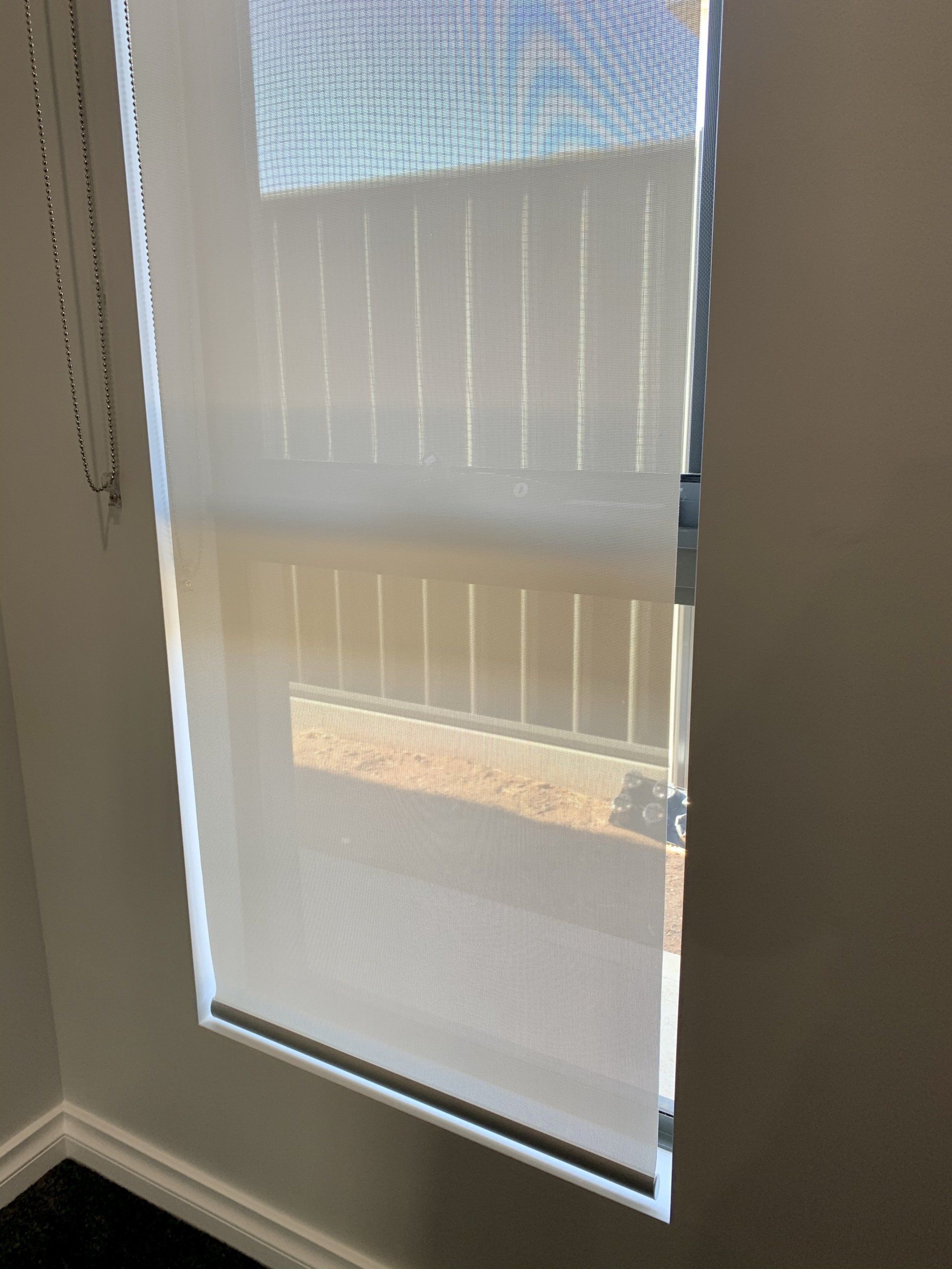 Roller Shade in A Window Partially Covering the Glass — Alice Mobile Blinds in Ciccone, NT