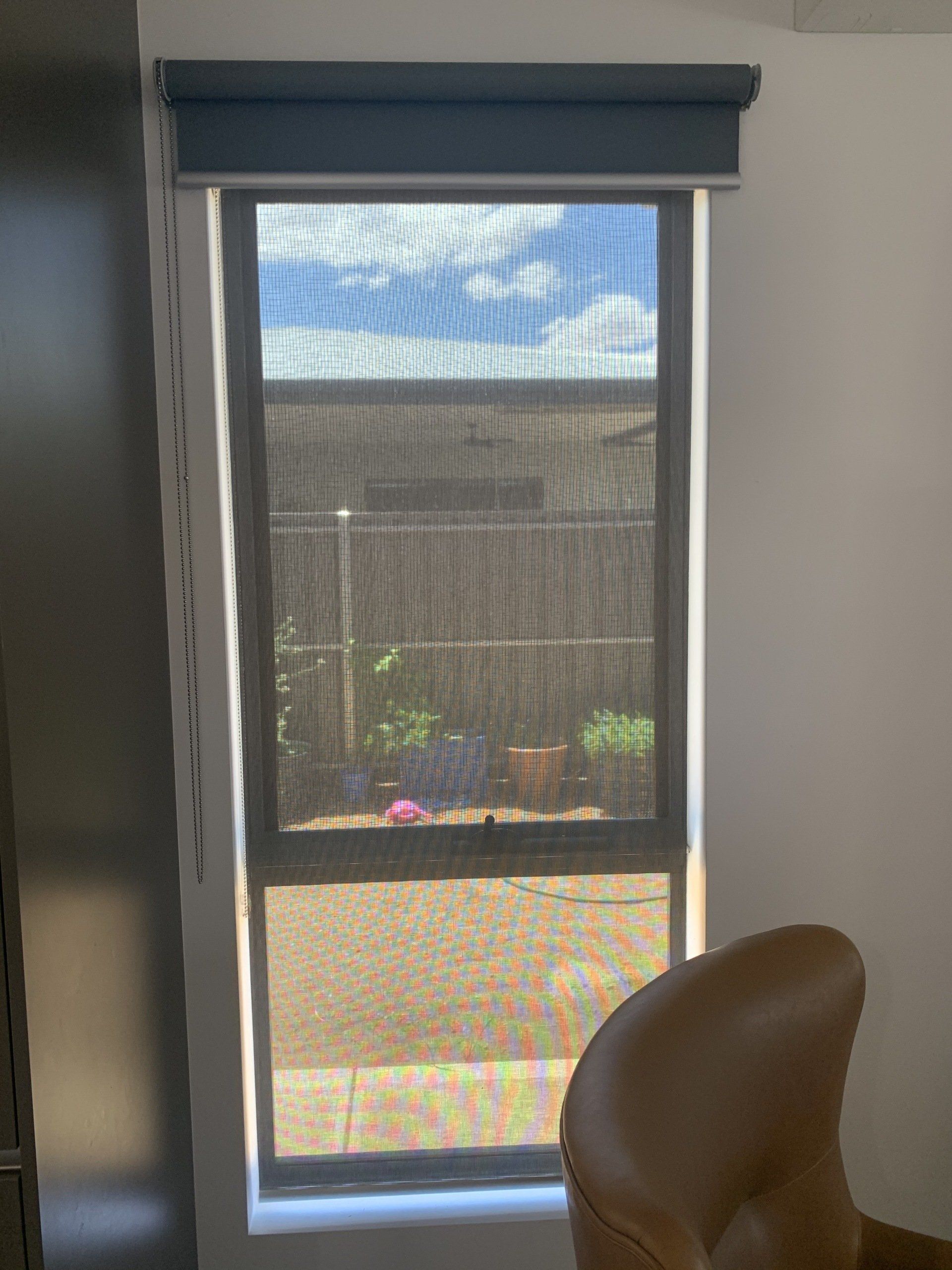Window with Blue Top Shade, Black Screen and Tan Chair — Alice Mobile Blinds in Ciccone, NT