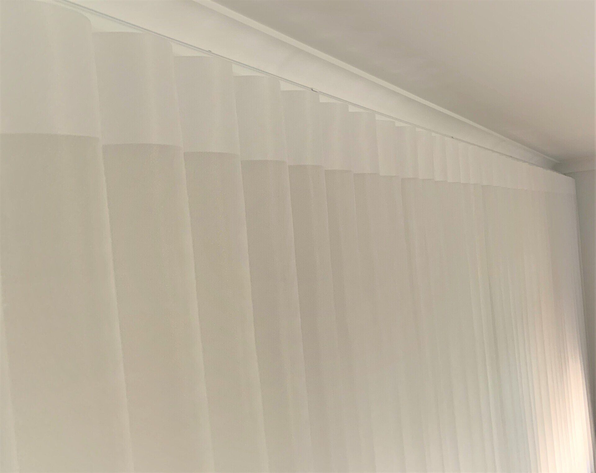 White Sheer Vertical Blinds Hanging from A Track on A Ceiling — Alice Mobile Blinds in Ciccone, NT