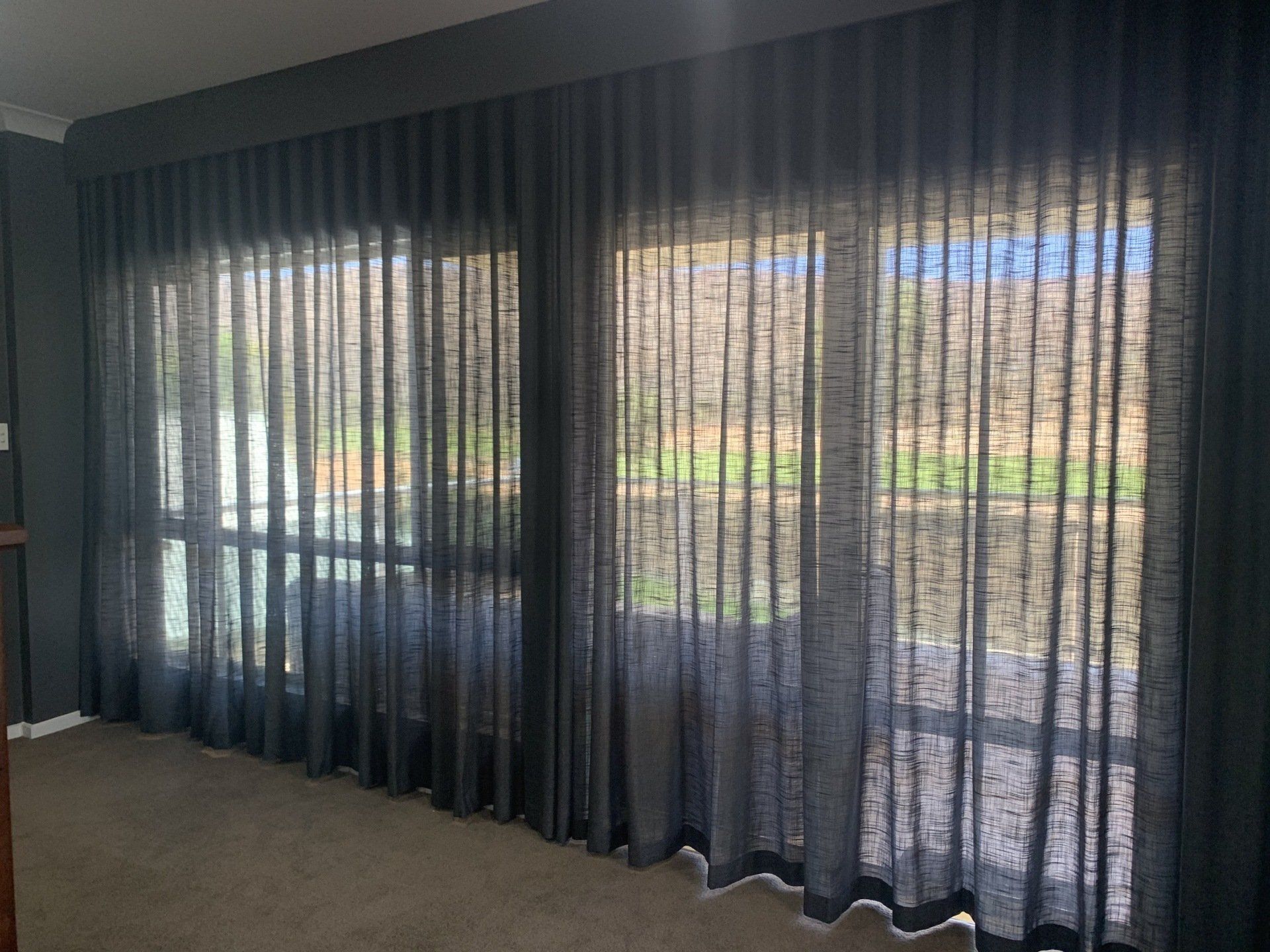 Dark Grey Sheer Curtains Covering a Window — Alice Mobile Blinds in Ciccone, NT