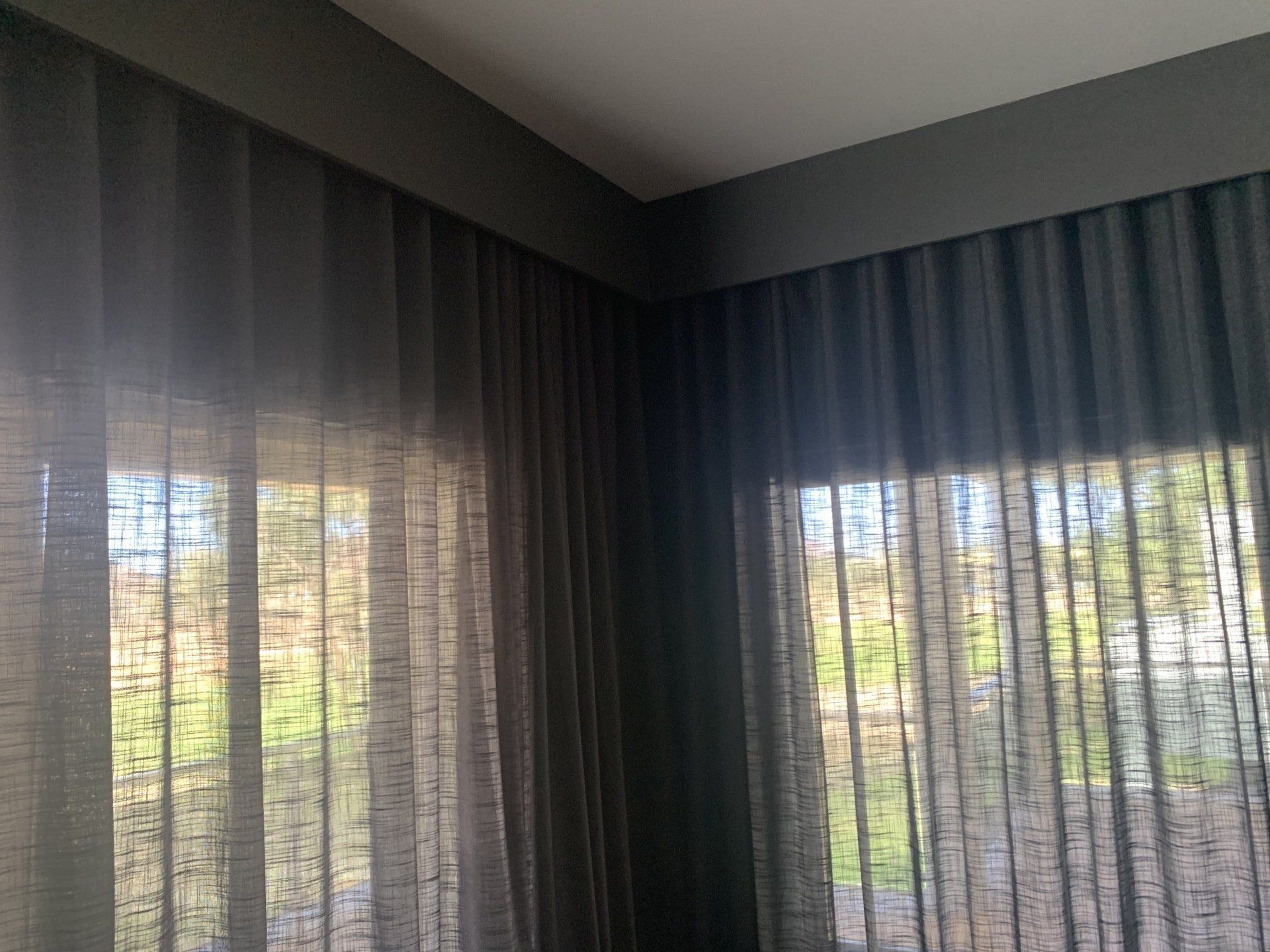 Dark Grey Sheer Curtains Frame Windows — Alice Mobile Blinds in Ciccone, NT