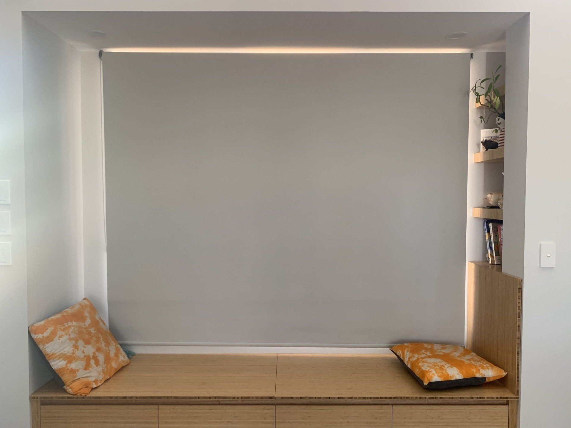 Built-In Window Seat with A Grey Roller Blind — Alice Mobile Blinds in Ciccone, NT