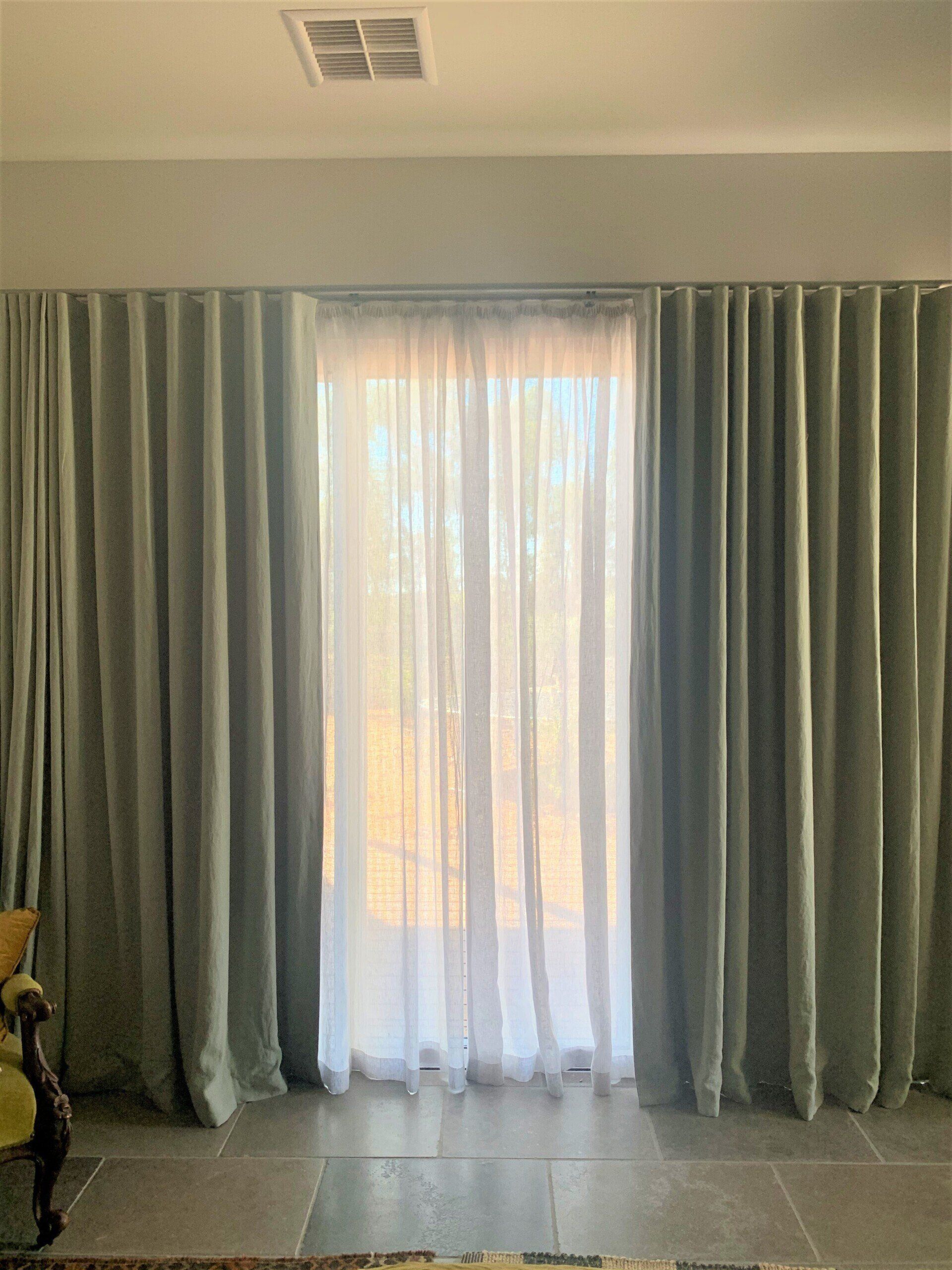 Pale Green Curtains Frame a Bright Window — Alice Mobile Blinds in Ciccone, NT