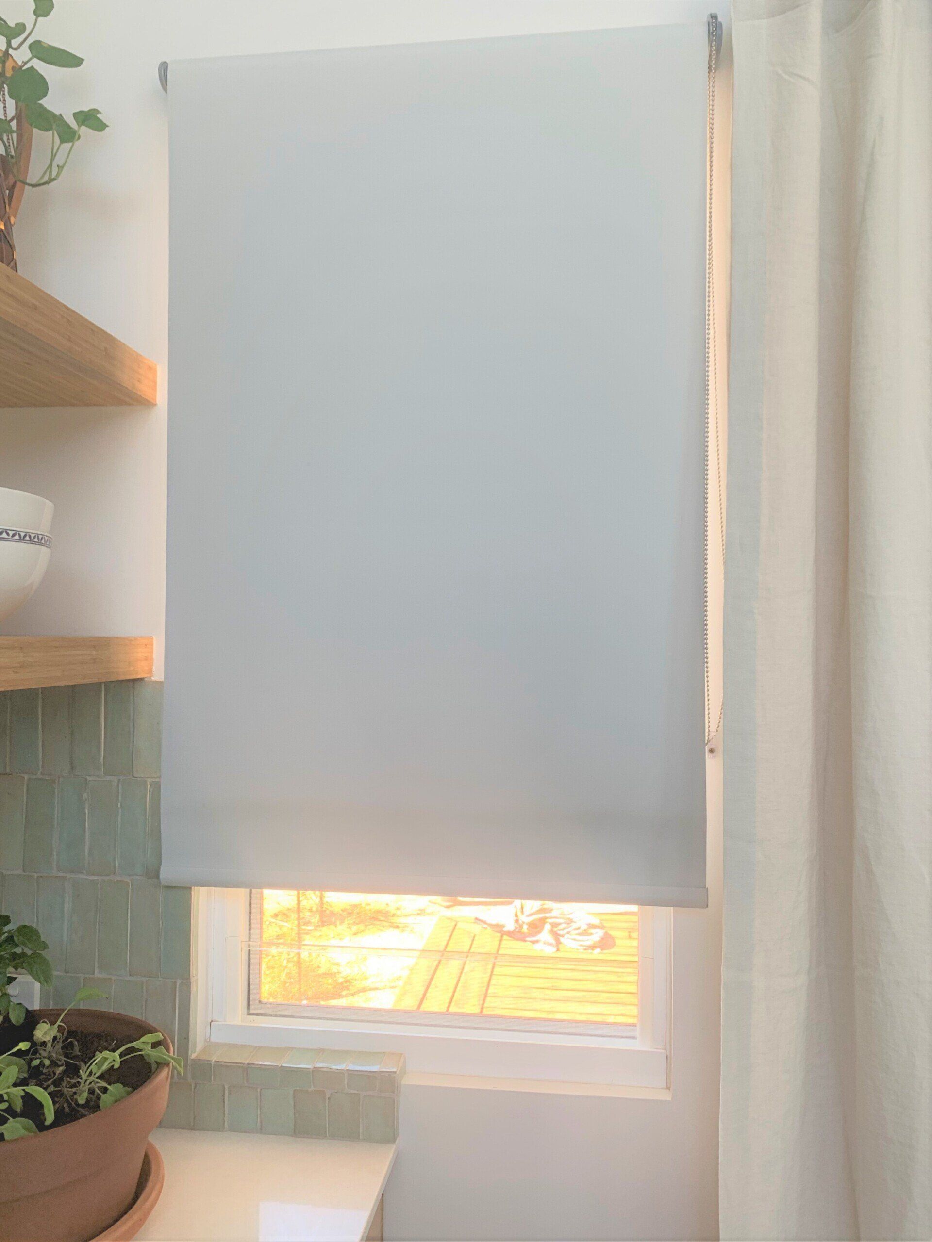 White Roller Blind Over a Window — Alice Mobile Blinds in Ciccone, NT