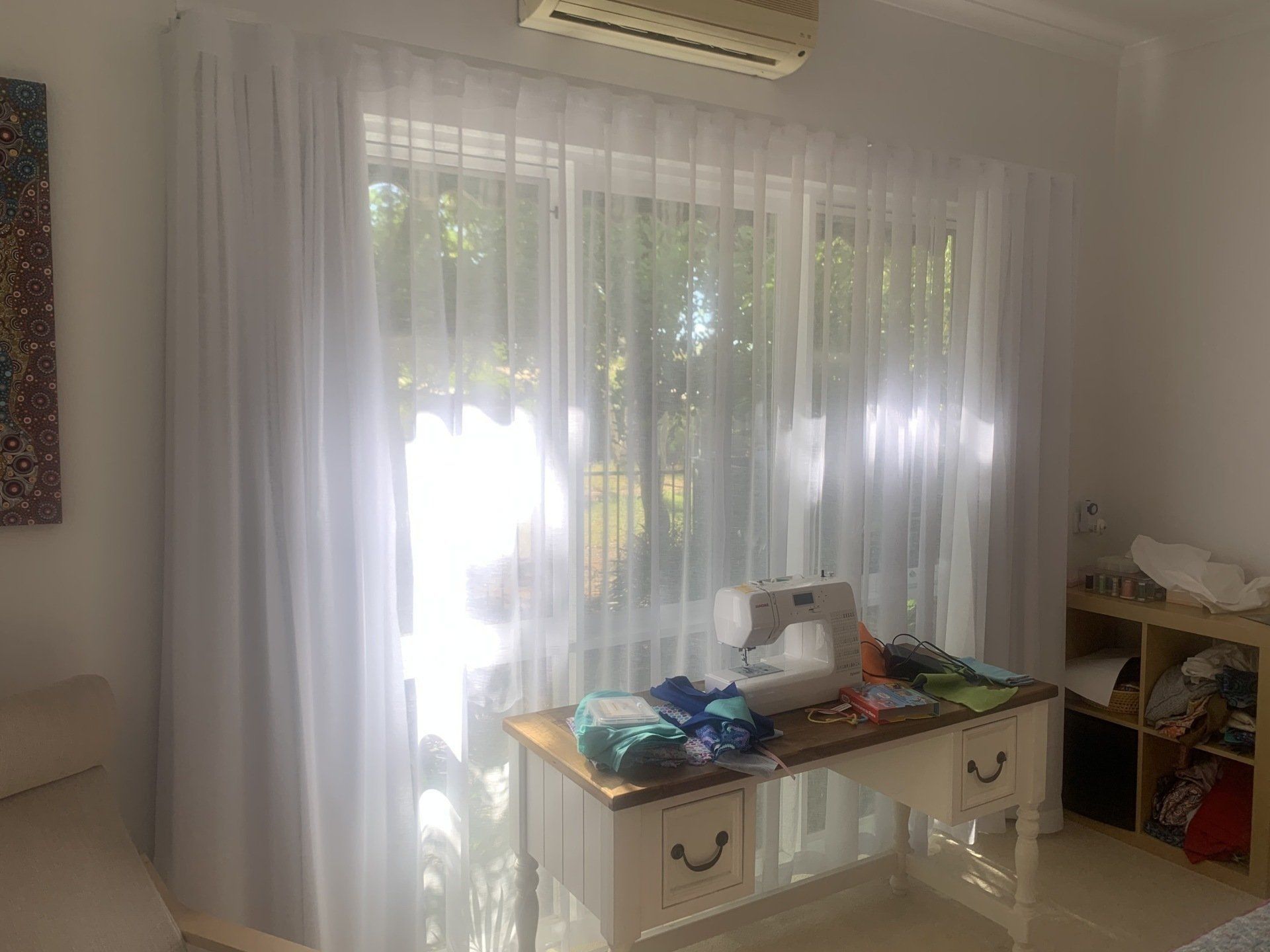 White Curtains Frame a Sunlit Window — Alice Mobile Blinds in Ciccone, NT
