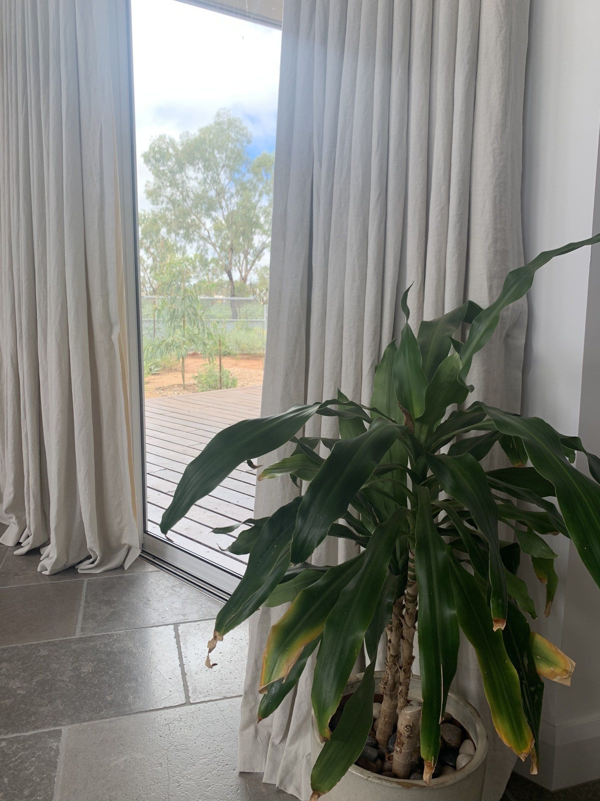 Indoor Scene with Light-Coloured Curtains Framing a Window — Alice Mobile Blinds in Ciccone, NT