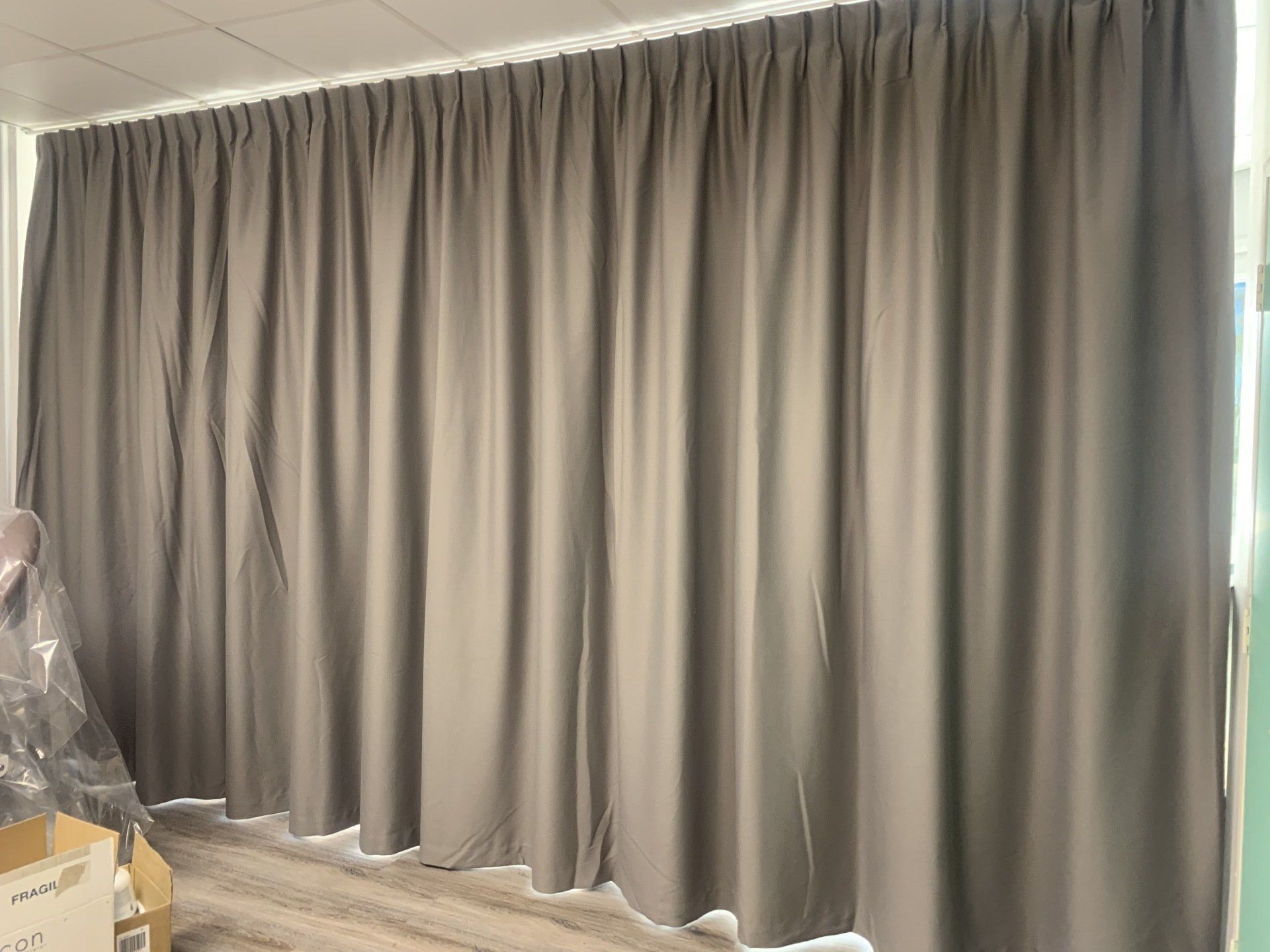 Grey Pleated Curtains Cover a Wall — Alice Mobile Blinds in Ciccone, NT