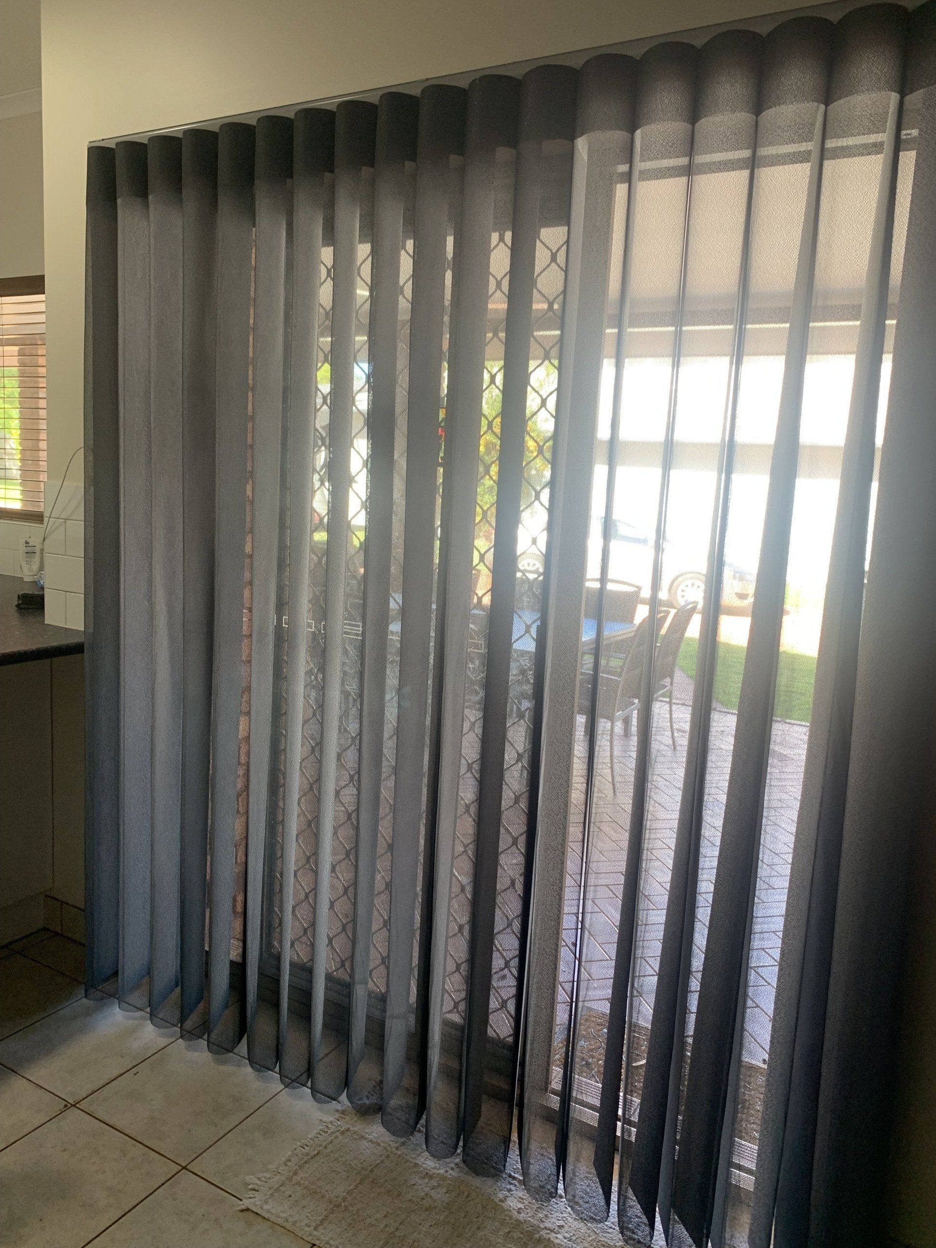 Sheer Grey Curtains Hanging in Front of A Glass Door — Alice Mobile Blinds in Ciccone, NT