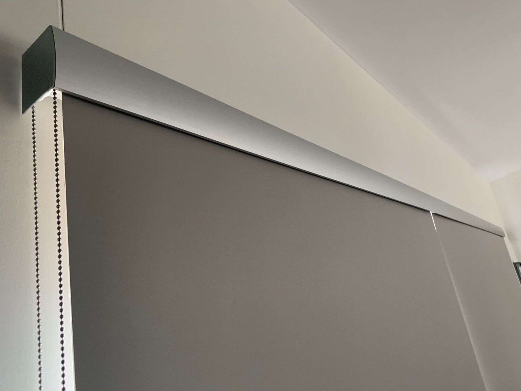Grey Roller Shade Partially Lowered with Silver Top Rail — Alice Mobile Blinds in Ciccone, NT