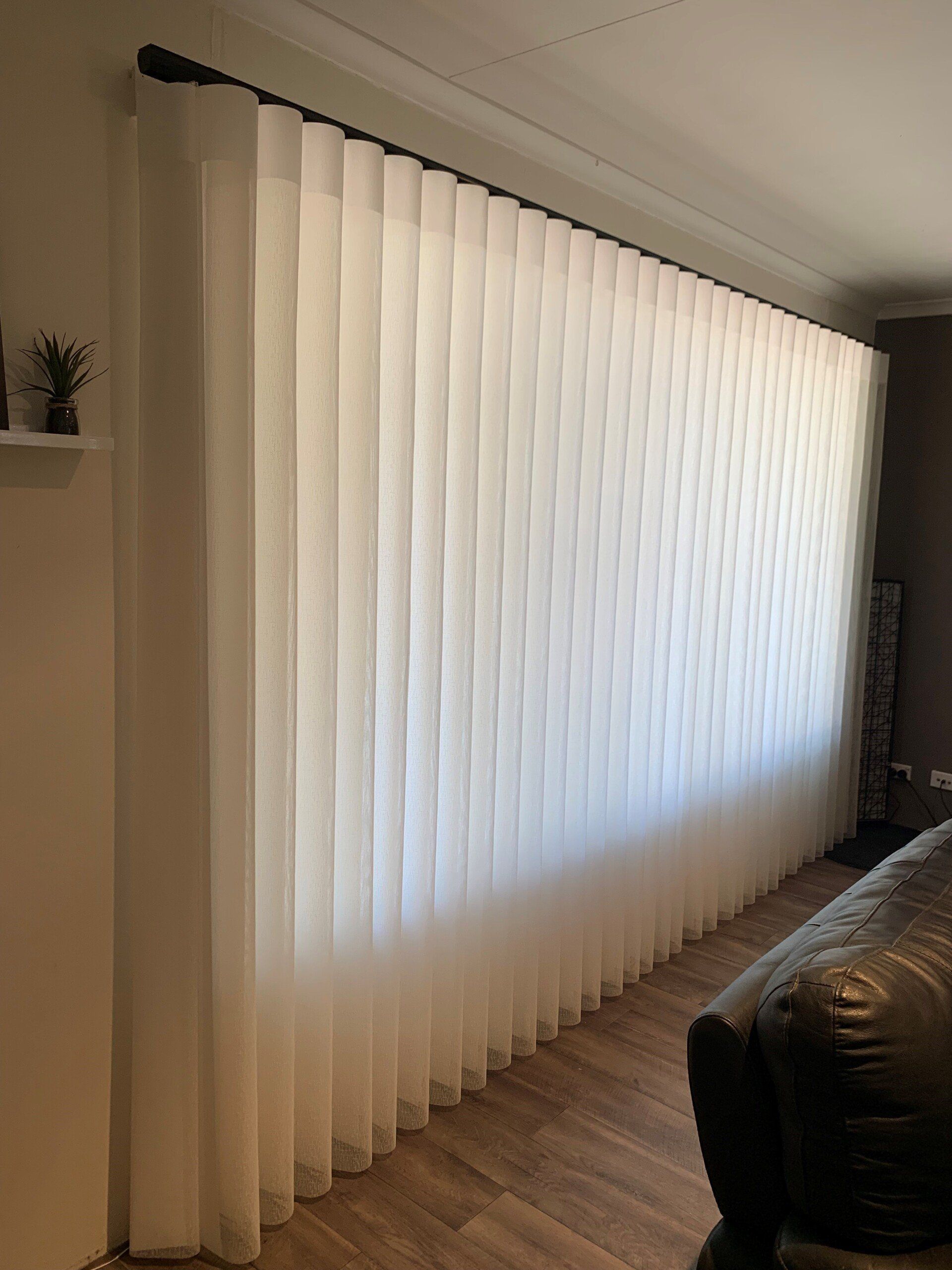 White Vertical Blinds Cover a Large Window in A Room — Alice Mobile Blinds in Ciccone, NT