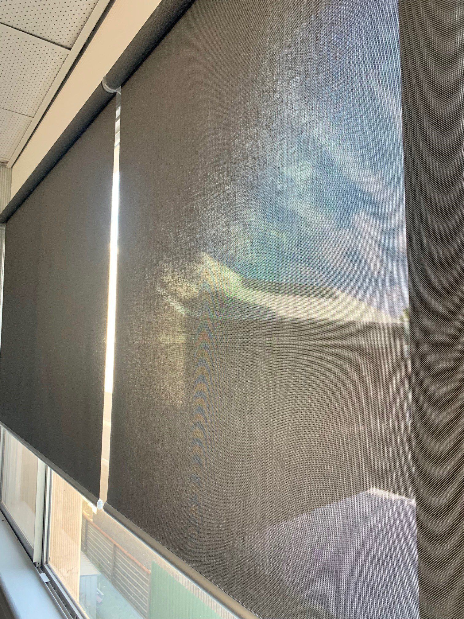 Dark Grey Roller on A Large Window — Alice Mobile Blinds in Ciccone, NT