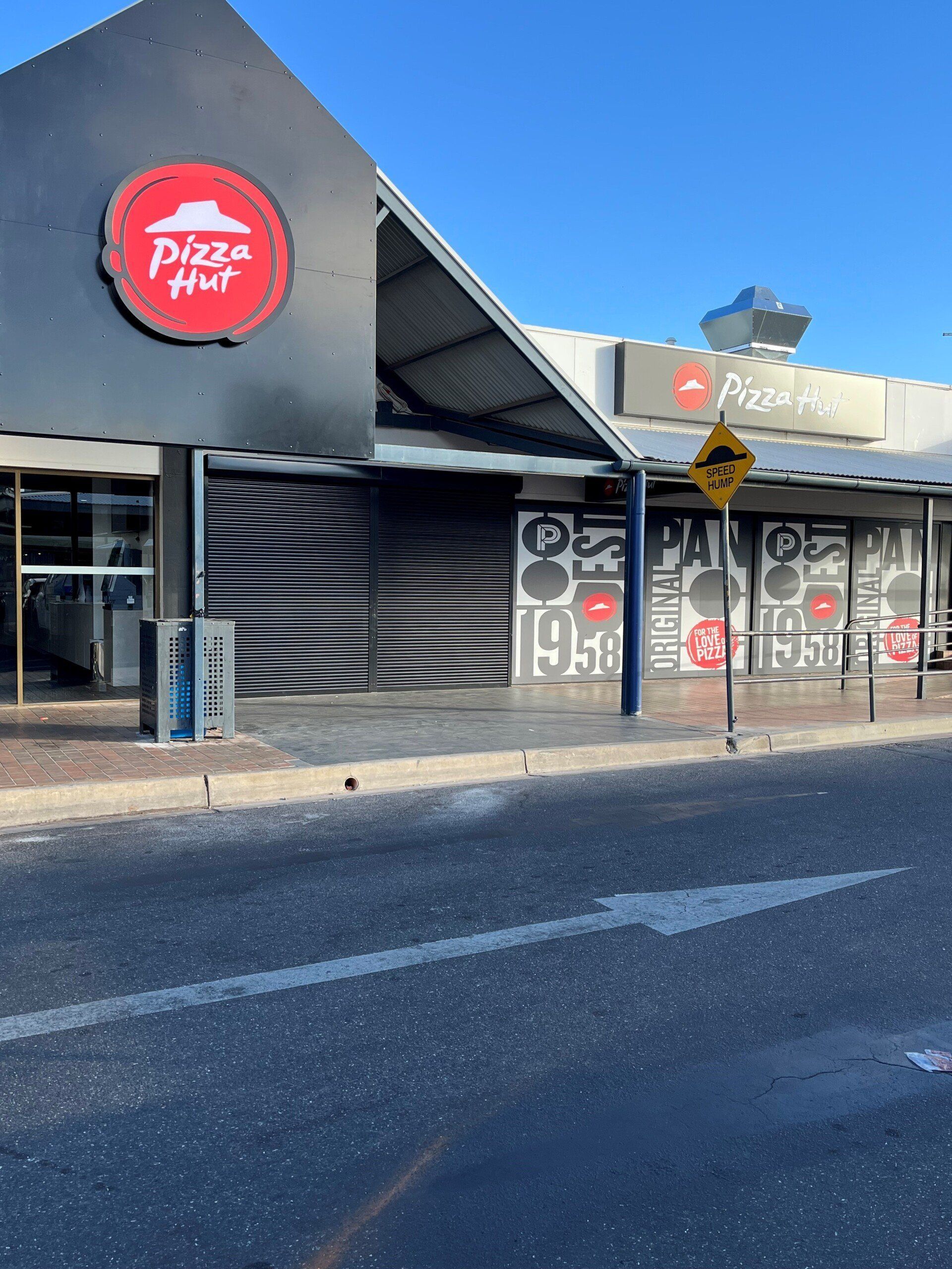 Exterior View of A Closed Pizza Hut with A Black Roller Shutter — Alice Mobile Blinds in Ciccone, NT