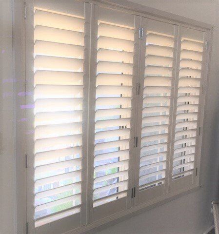 White Interior Shutters on A Window — Alice Mobile Blinds in Ciccone, NT
