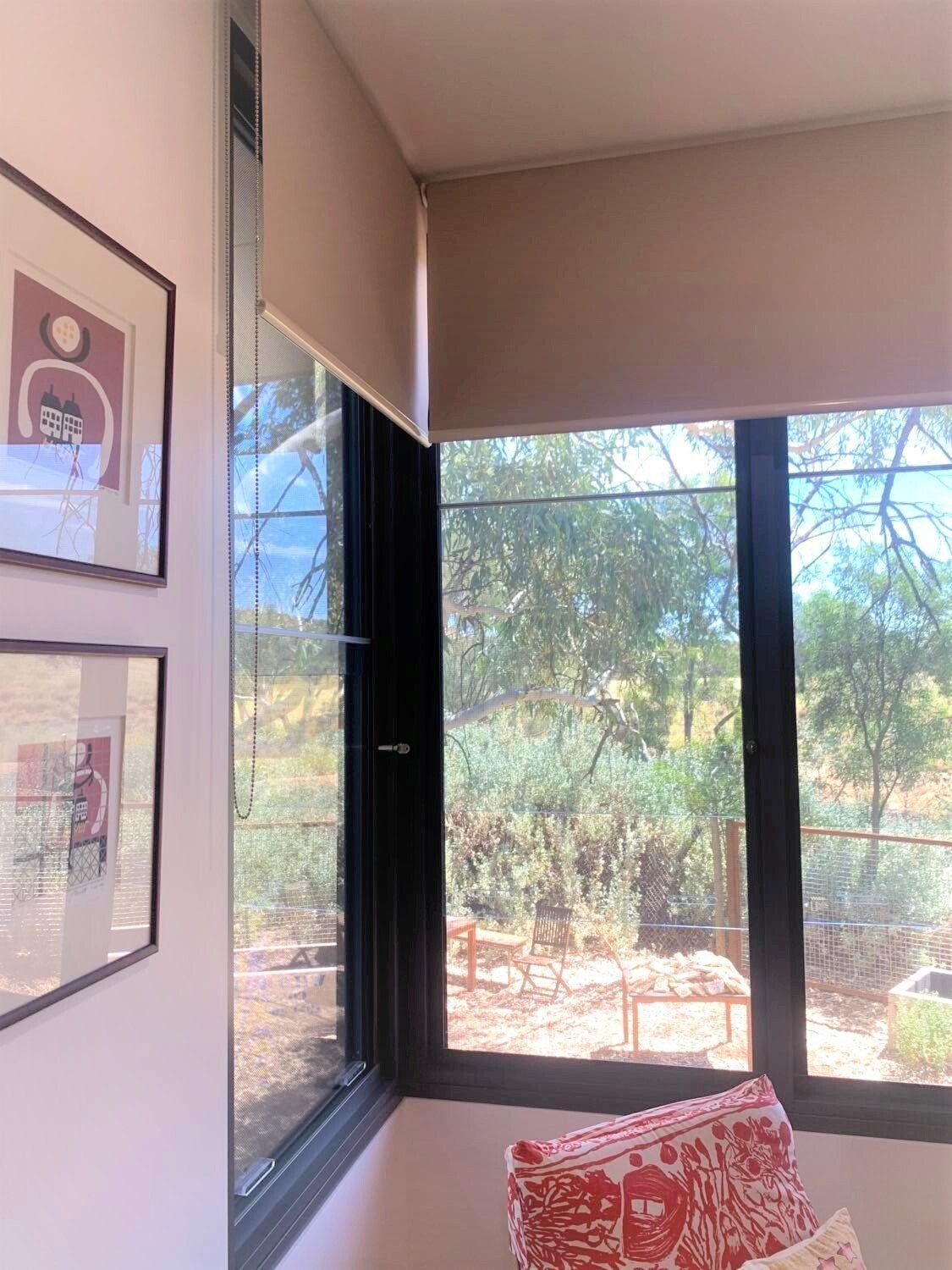 Corner Room with Framed Art, Window with Partially Drawn Tan Blind — Alice Mobile Blinds in Ciccone, NT