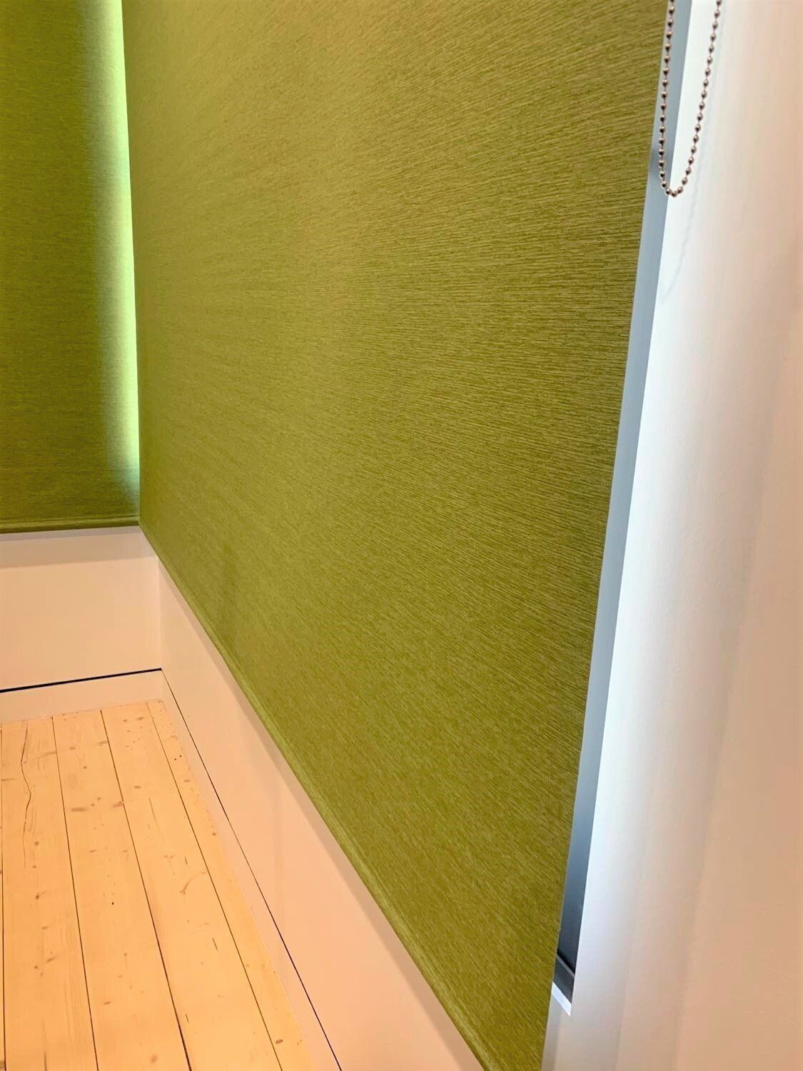 Green Fabric Wall Panel, Light Wood Floor, White Trim with Window — Alice Mobile Blinds in Ciccone, NT