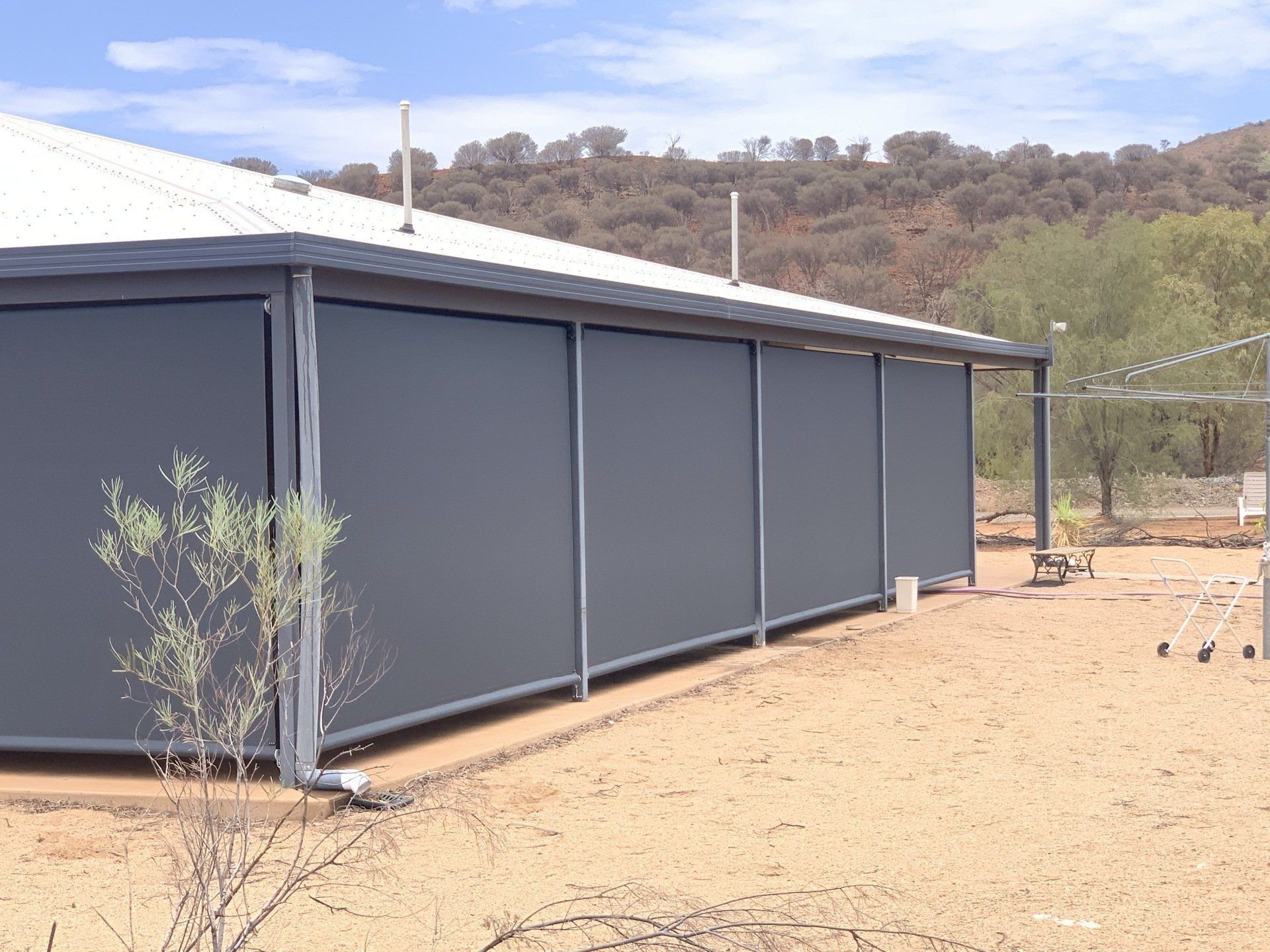 Building with Grey Shades Installed on The Exterior — Alice Mobile Blinds in Ciccone, NT
