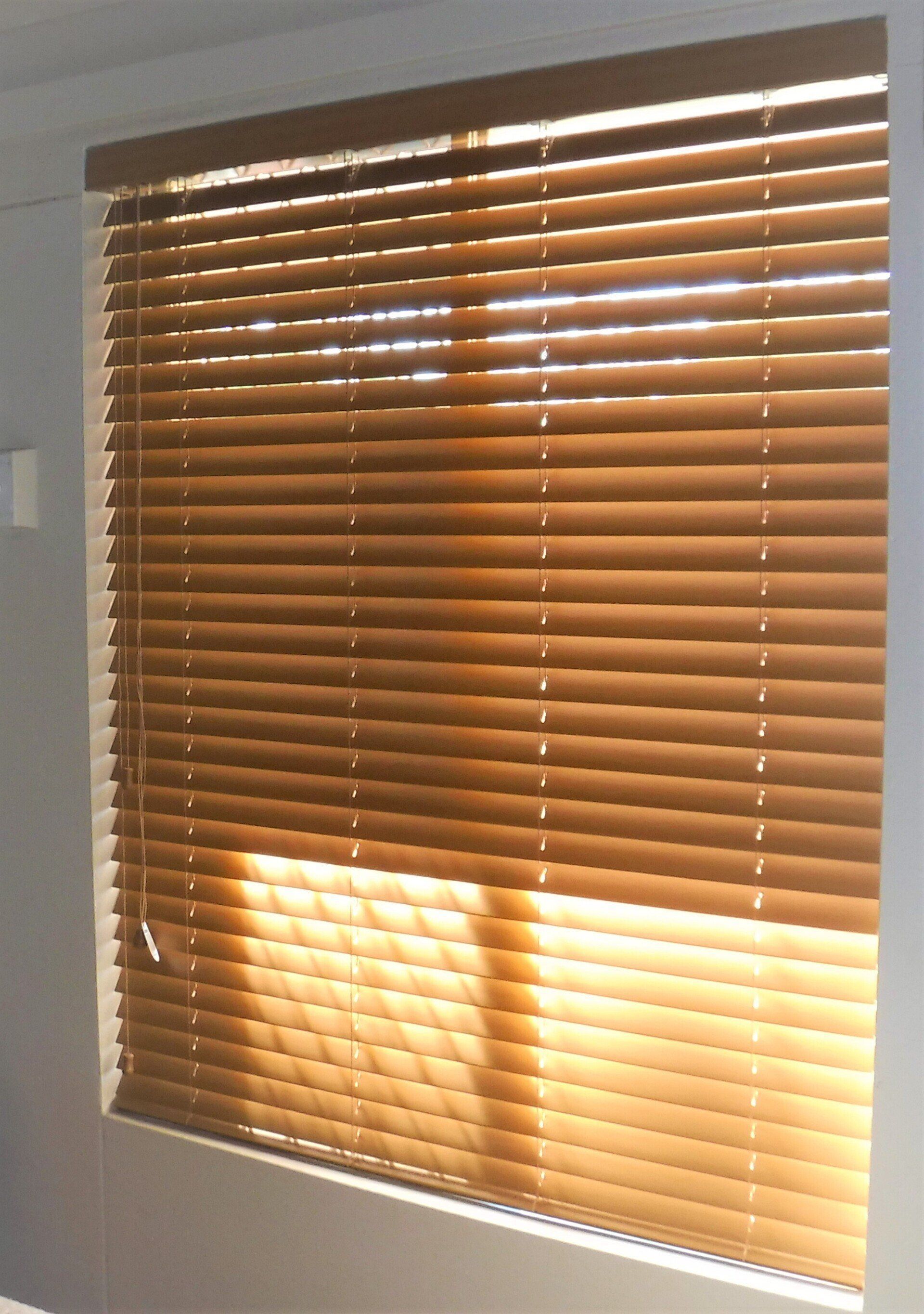 Wooden Blinds in A Window with Sunlight Shining Through the Slats — Alice Mobile Blinds in Ciccone, NT