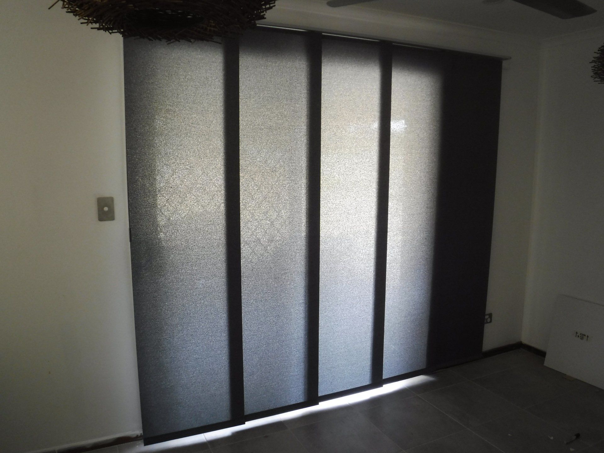 Black Panel Track Blinds Cover a Window — Alice Mobile Blinds in Ciccone, NT
