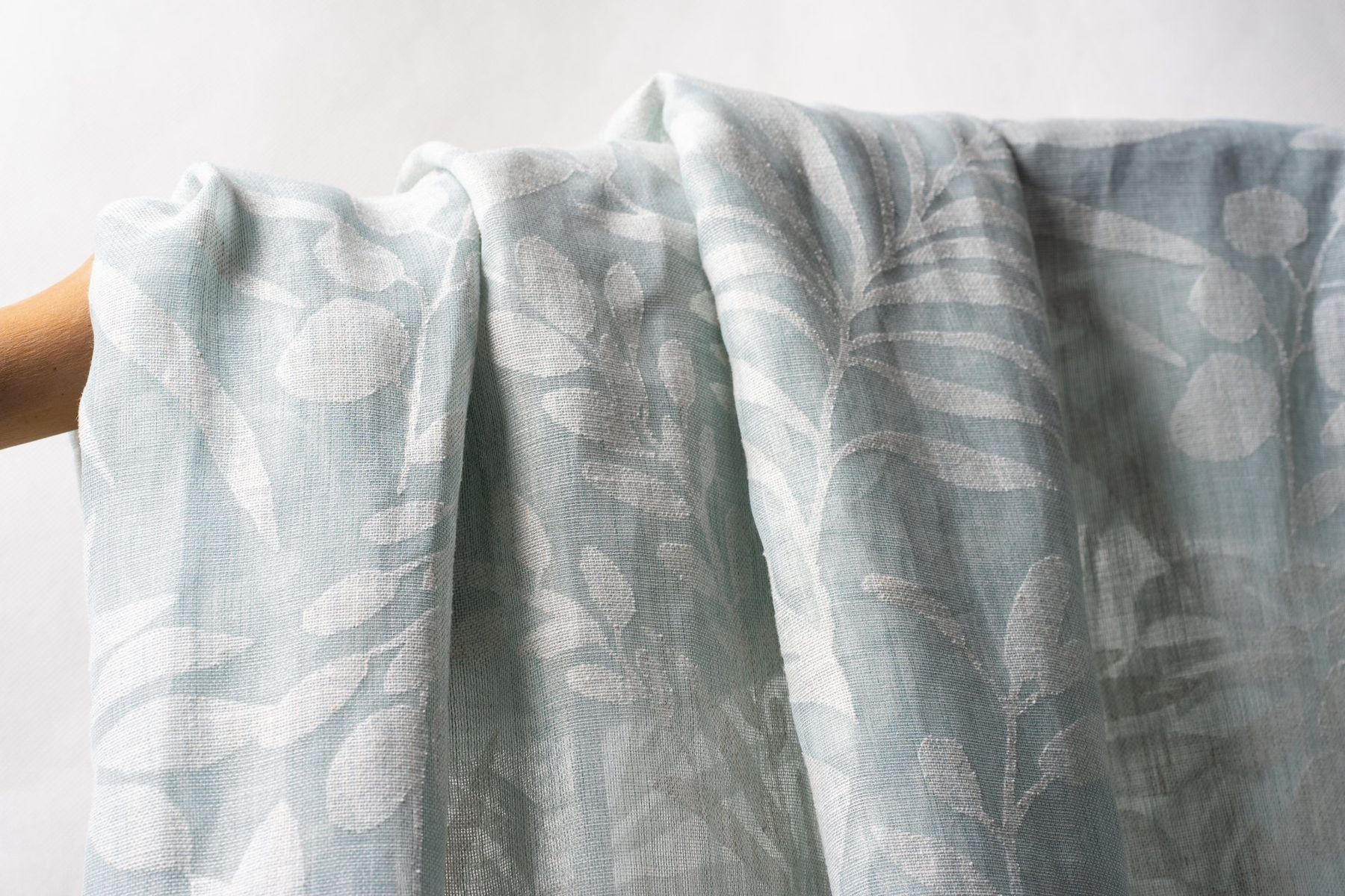 Blue and White Patterned Fabric Draped Over a Wooden Rod — Alice Mobile Blinds in Ciccone, NT
