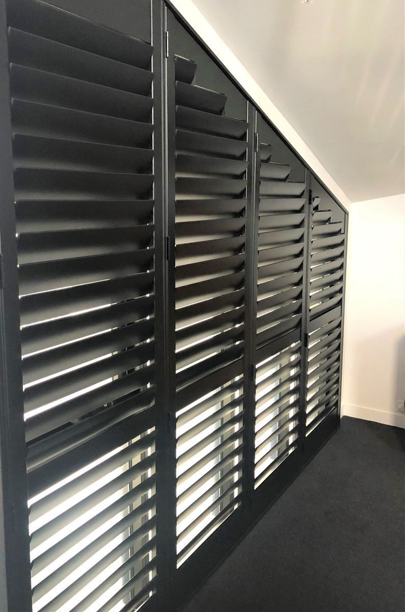 Dark Grey Shuttered Wall Covering a Window with Angled Slats — Alice Mobile Blinds in Ciccone, NT