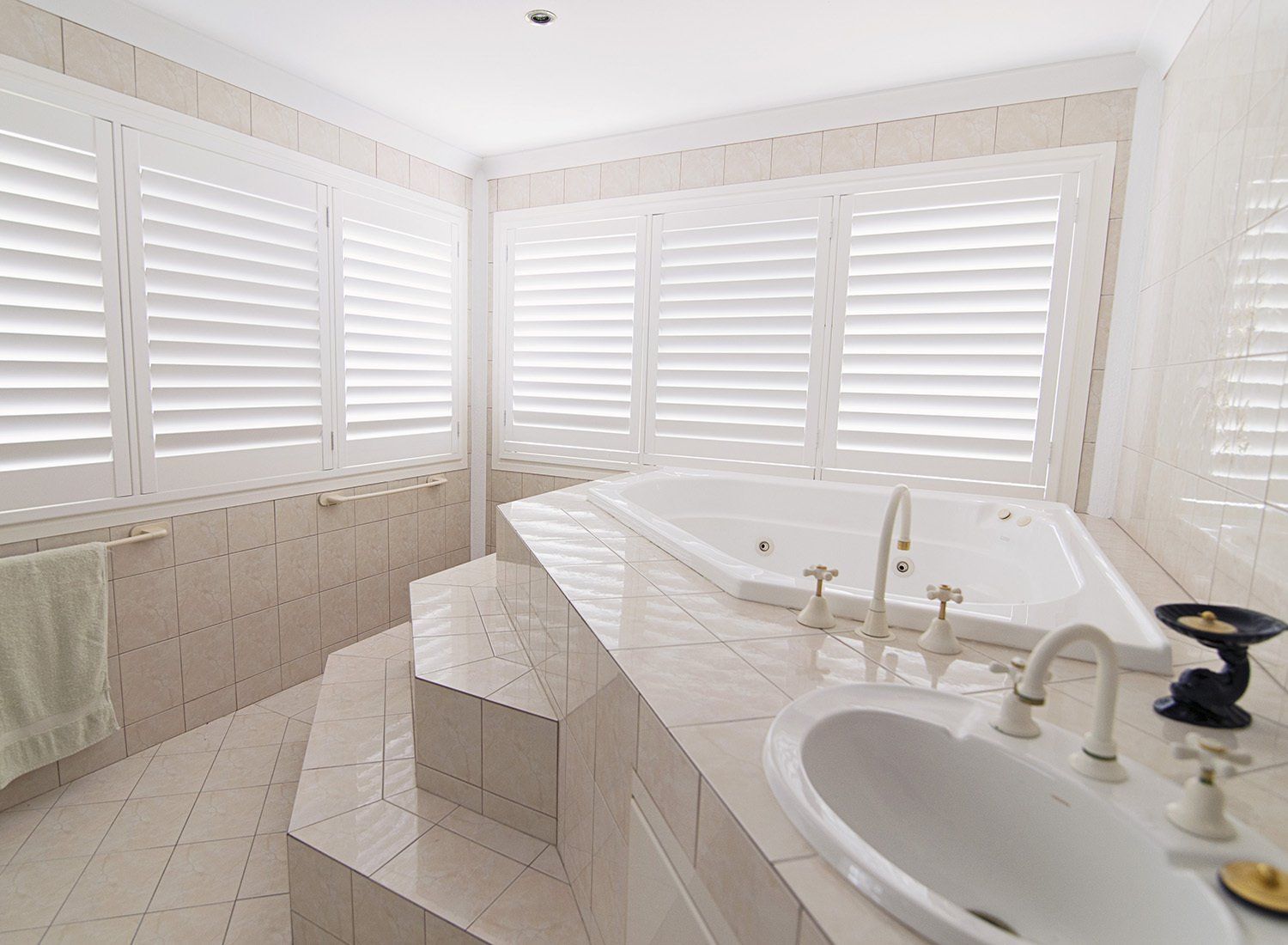 White Bathroom with Shutters, Jacuzzi and Sink — Alice Mobile Blinds in Ciccone, NT