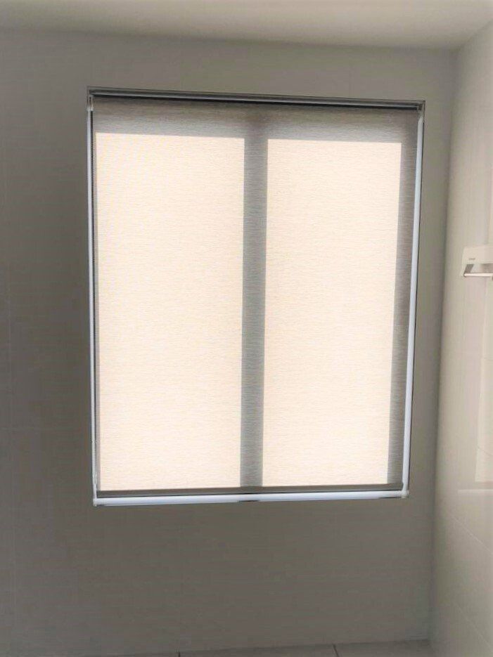 Window with Beige Roller Shades Set Against a Plain Wall — Alice Mobile Blinds in Ciccone, NT