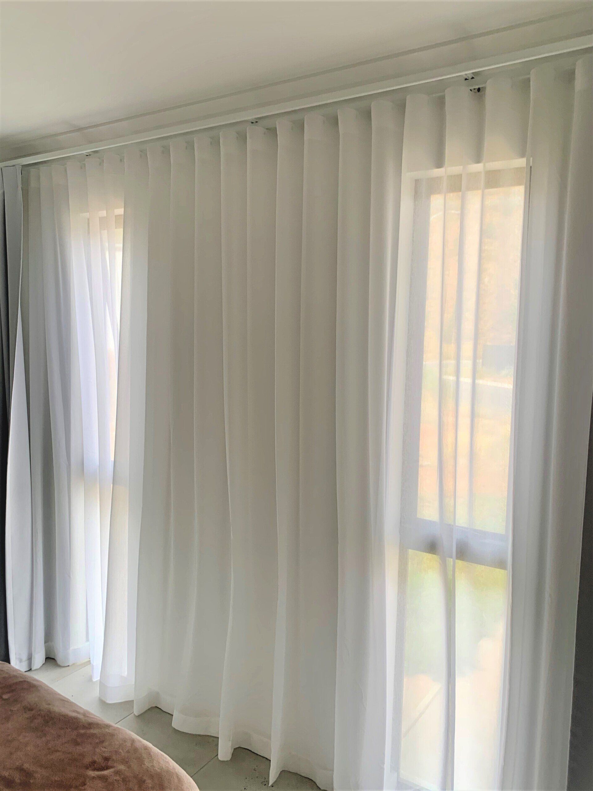 Sheer White Curtains Hang in Front of Two Windows — Alice Mobile Blinds in Ciccone, NT