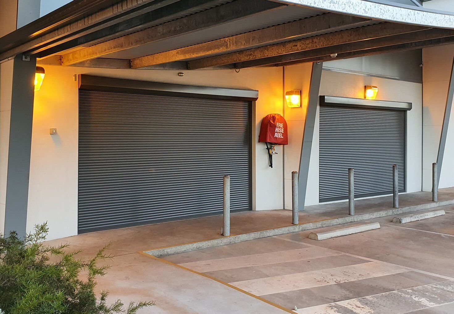 Two Closed Metal Roller Doors Under a Canopy — Alice Mobile Blinds in Ciccone, NT