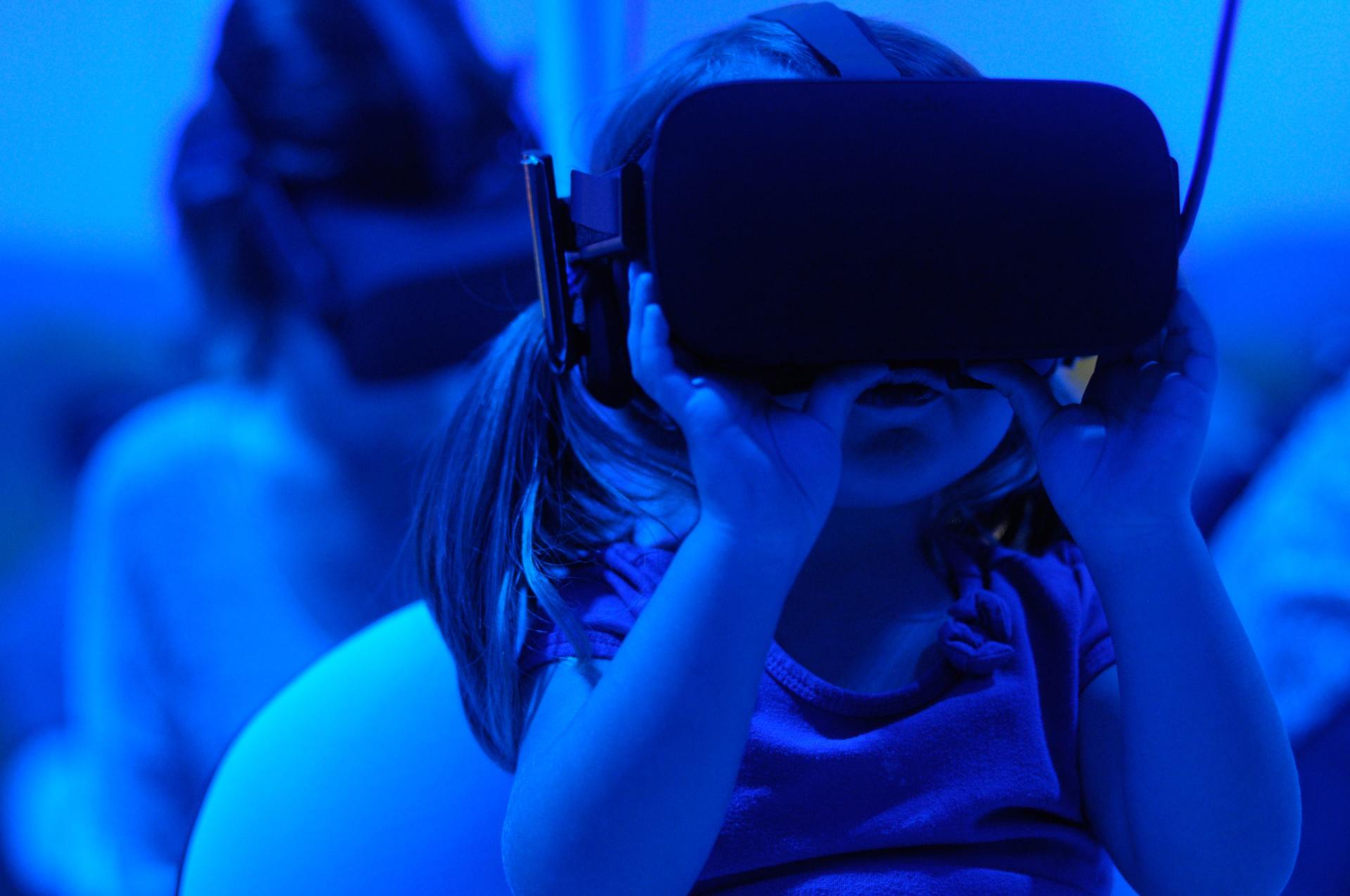 Ein kleines Mädchen trägt ein Virtual-Reality-Headset.